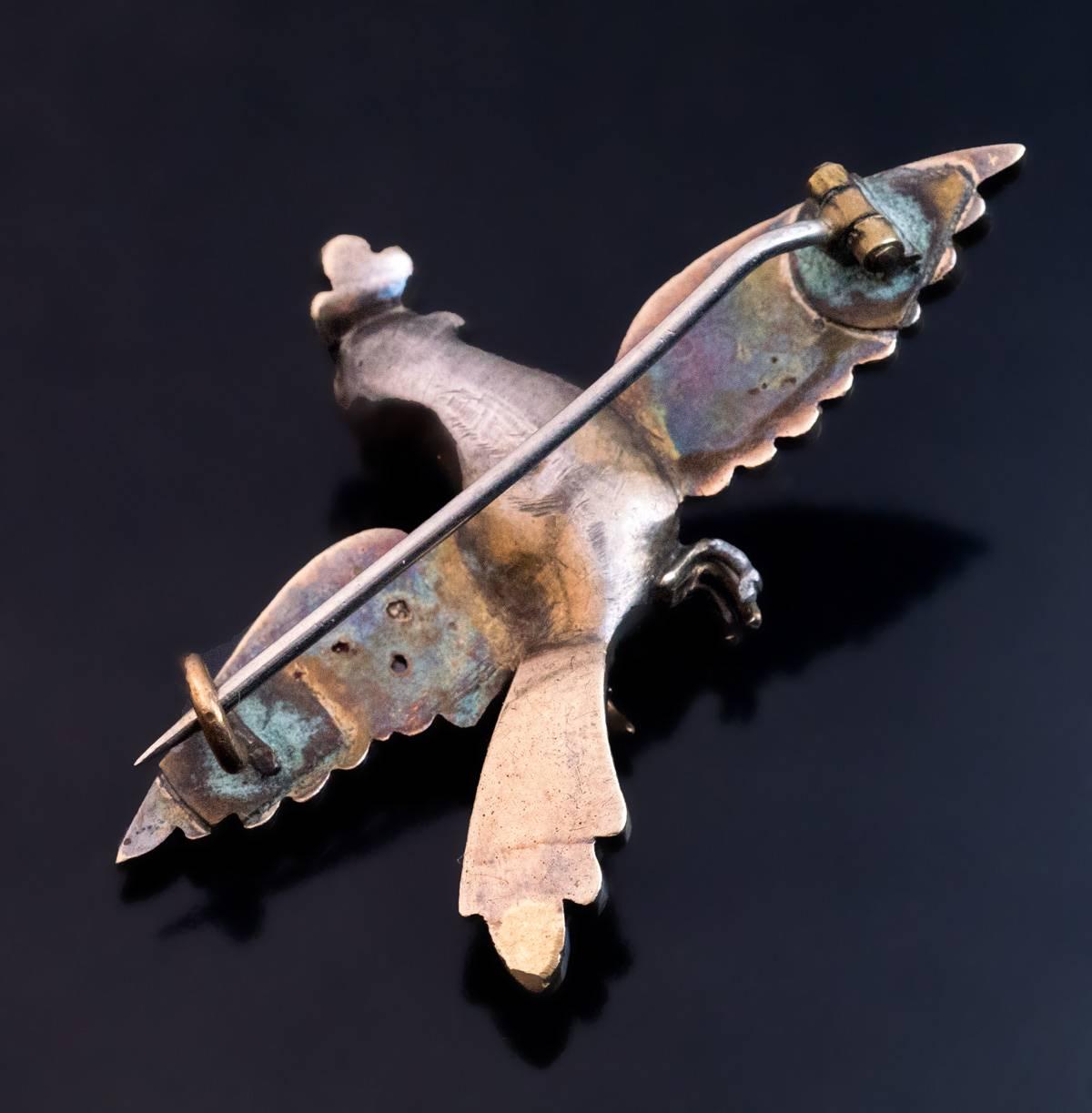 This is a very fine and extremely rare museum quality antique Georgian “bird of paradise” silver topped gold brooch from the mid 18th century. The brooch is embellished with rose cut diamonds, opaque blue enamel and red & green translucent