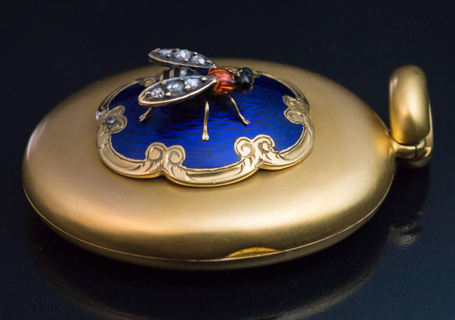 Circa 1890

An antique 14K matte gold locket is embellished with a royal blue guilloche enamel medallion with a hand-engraved scrolling border, mounted with a miniature enamel and rose-cut diamond fly.

Size without bail 33 x 26 mm (1 3/8 x 1