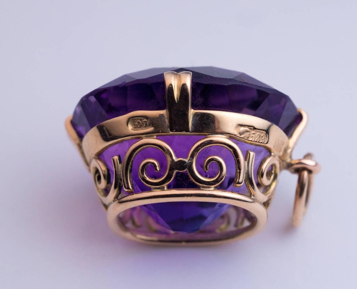 Made in Moscow in the 1930s

A 14k gold pendant features a sparkling medium purple cushion-cut Siberian amethyst measuring 16 x 14.1 x 11.2 mm, approximately 14.73 ct.

The pendant is marked on frame with early Soviet assay mark for 583 gold