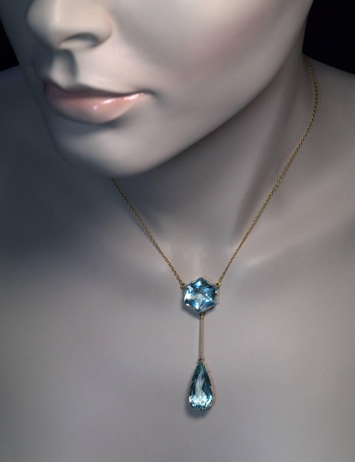 Made in Moscow between 1908 and 1917

A 14K gold necklace features two aquamarines:

One hexagonal  – 13.7 x 13.7 x 8.7 mm, approximately 10.21 ct.

One drop shaped – 20.92 x 10.34 x 6.7 mm, approximately 7.15 ct.

Marked with 56 zolotnik