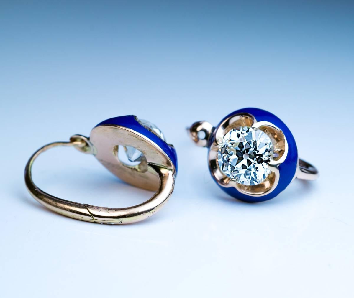 Circa 1890

Antique Victorian era gold earrings feature two sparkling old cushion cut diamonds 1.01 ct and 1.03 ct (J color, VS1 and SI1 clarity) set in cushion shaped blue enamel bezels.

Width 10 mm (3/8 in.)

Total length with ear wire 17