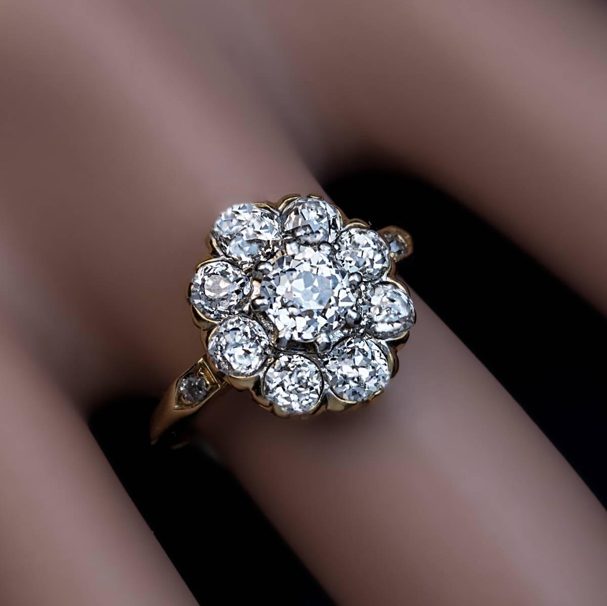 Circa 1915

An 18K gold diamond cluster ring of a classical design is centered with a sparkling old cushion cut diamond (5.1 x 4.9 x 3.6 mm, approximately 0.69 ct) set in platinum prongs surrounded by eight old mine cut diamonds set in gold. The