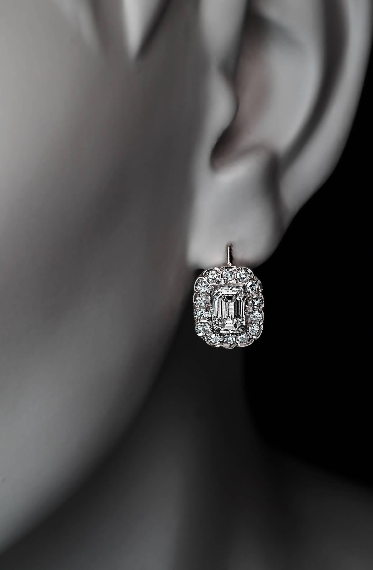 Vintage Soviet Russian diamond cluster earrings, circa 1960s, feature two sparkling emerald cut diamonds: 6.3 x 4.4 x 3.2 mm, approximately 0.78 ct and 6.7 x 4.95 x 3 mm, approximately 0.87 ct, surrounded by single cut diamonds.

Estimated total