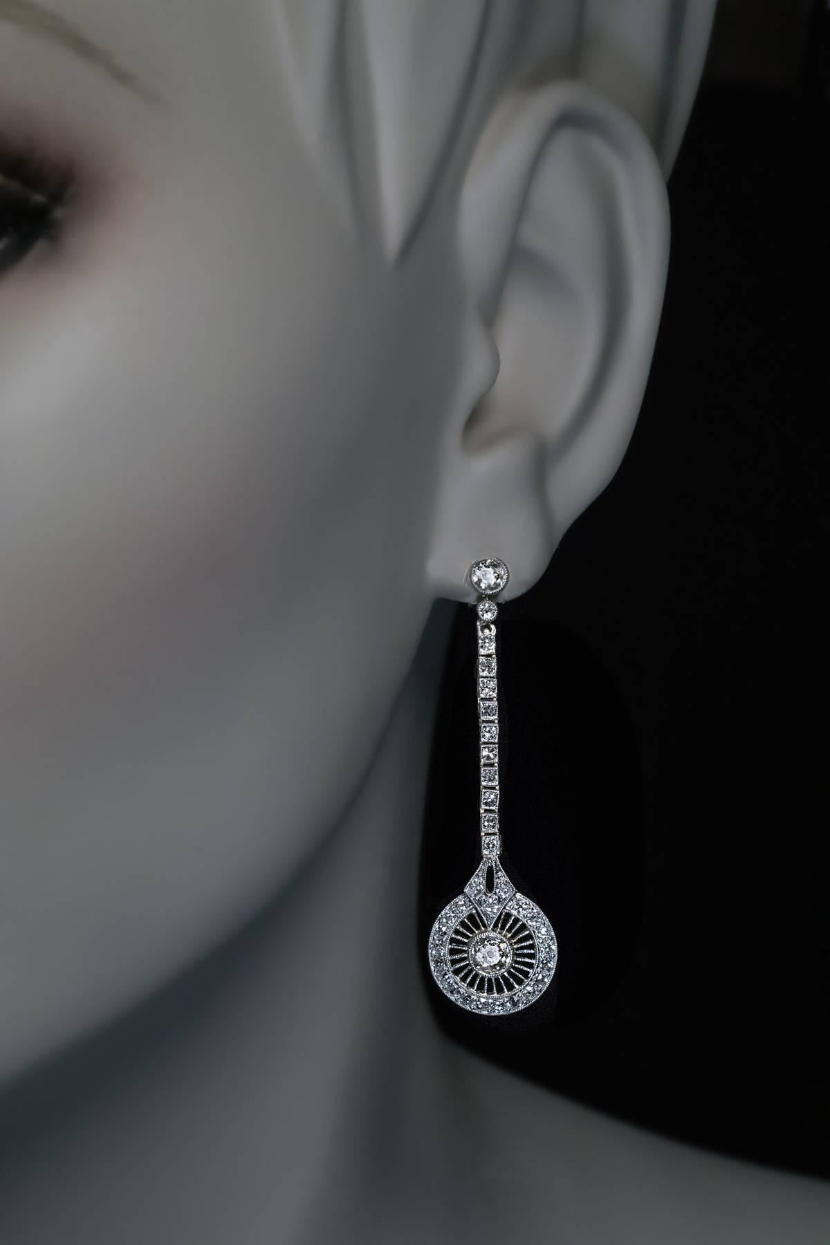 A pair of stylish 1920s Art Deco vintage long earrings handcrafted in platinum topped 18K gold and set with sparkling old cut diamonds.

Estimated total diamond weight 3 carats.

The earrings are marked with maker’s mark and initials.

Length 50 mm