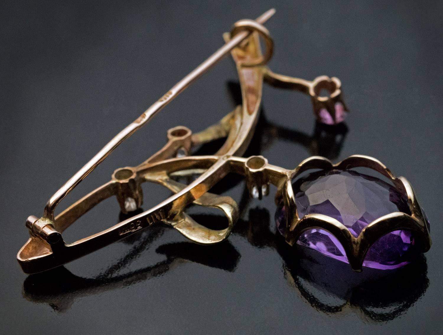 Made in Moscow between 1899 and 1908

A rose and green 14K gold brooch is designed as a branch with berries. The brooch is set with an oval amethyst, a pink tourmaline and three diamonds.

Marked with 56 zolotnik Imperial gold standard with