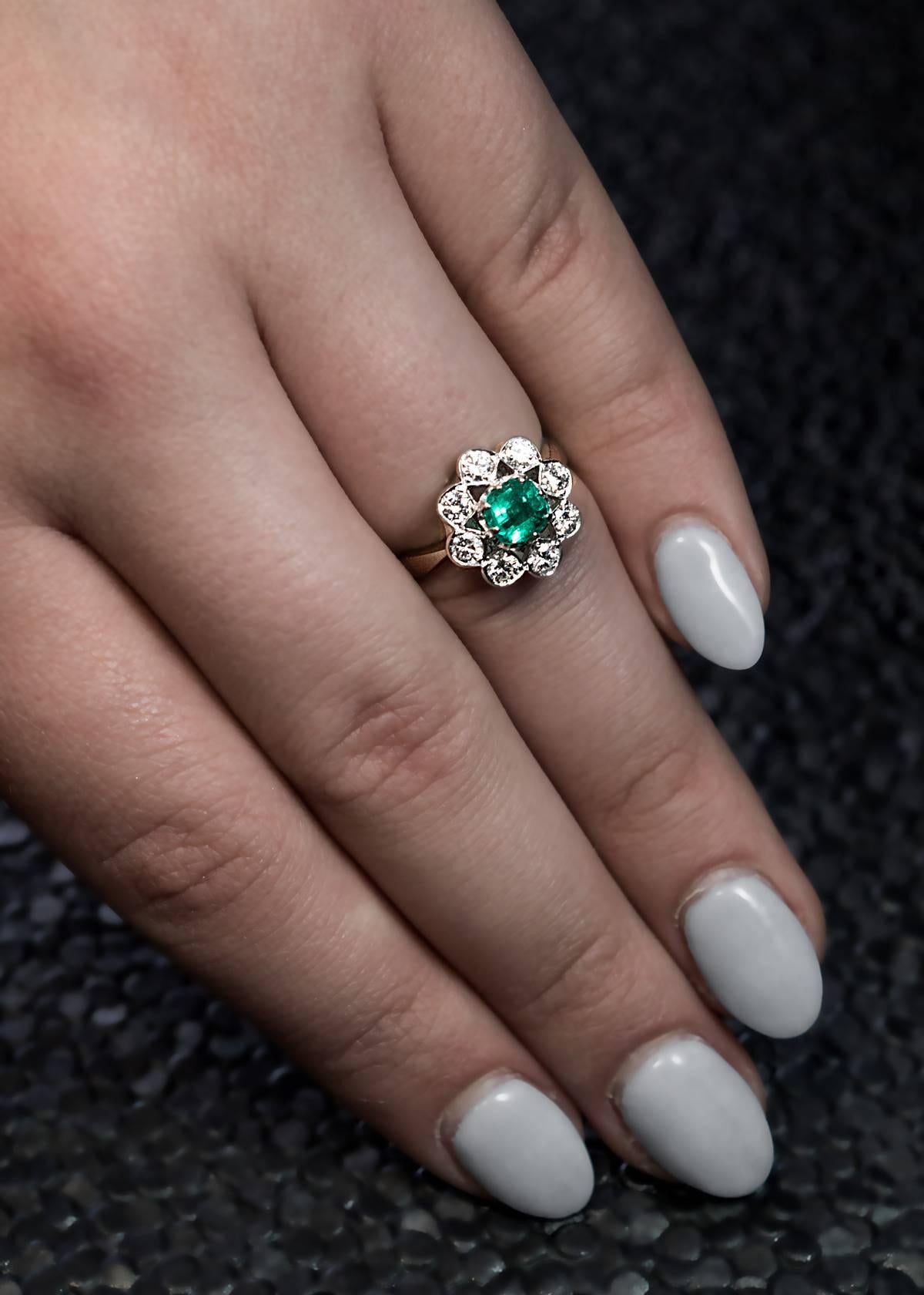Austrian, Vienna, circa 1960s
A mid-century finely crafted 14K white gold openwork cluster ring is centered with a square emerald cut emerald (measuring 5.23 x 5.13 x 3.8 mm, approximately 0.71 ct) surrounded by brilliant cut diamonds of excellent