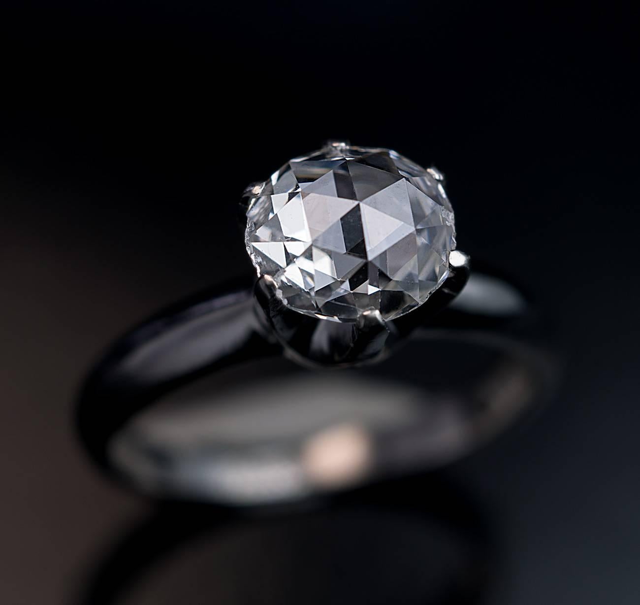 Circa 1930s
This vintage platinum engagement ring features an excellent 0.83 ct old rose cut diamond. The diamond is of a slightly oval shape:  7.12 x 6.48 x 2.3 mm. The color is bright white D-E, clarity VS1.

The ring is marked with a 900 platinum