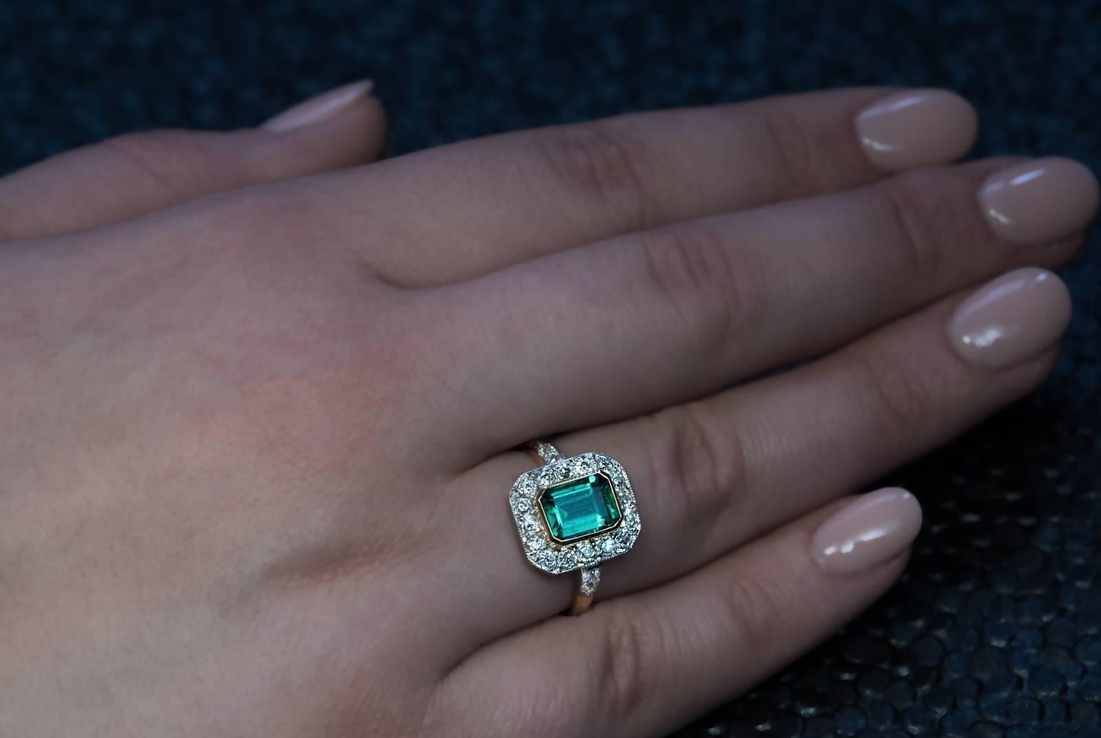 French, circa 1910
A platinum and 18K yellow gold ring is centered with a very fine 1.39 ct natural emerald set in a gold bezel framed by sparkling old mine cut diamonds. The shoulders of the ring are embellished with four old mine diamonds. The