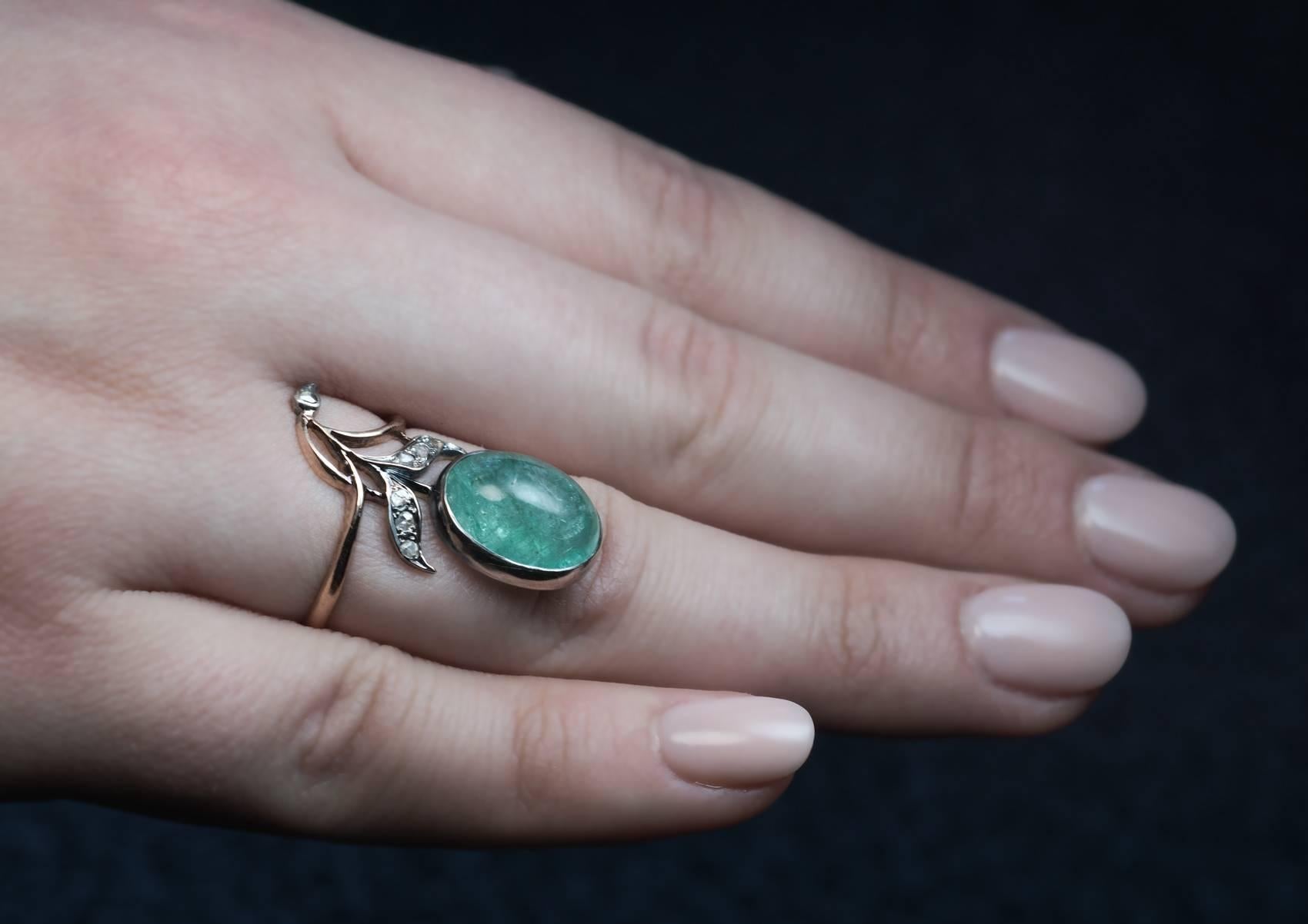Made in Moscow between 1899 and 1904.
A silver-topped 14K gold ring is designed as a stylized flower in Art Nouveau taste. The flower is set with a big cabochon cut emerald accented with old rose cut diamonds.

The emerald measures 14 x 10.6 x 7.1