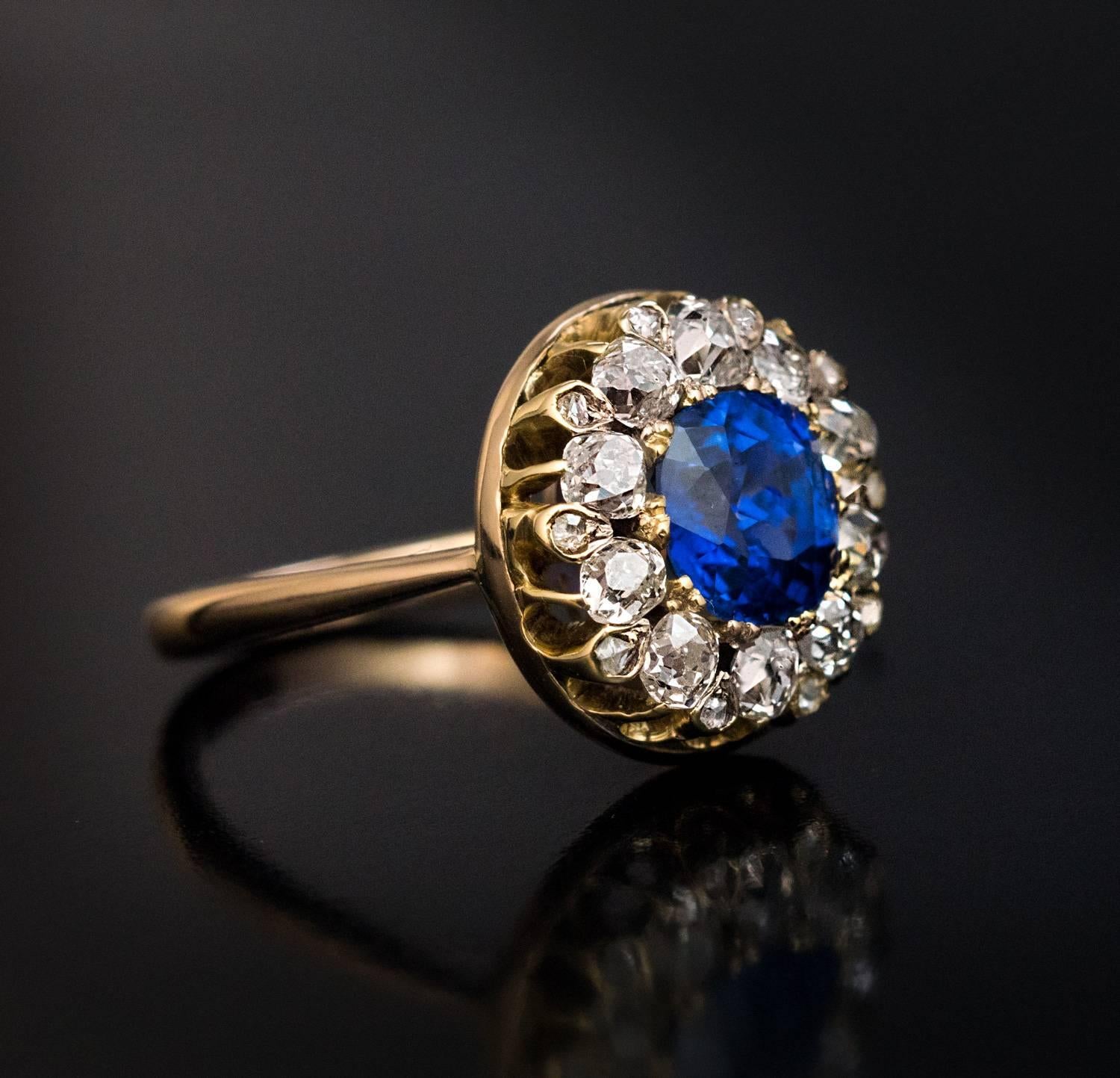 Circa 1890
An antique 14K gold ring is centered with an excellent vivid royal blue cushion cut 2.06 ct sapphire from Burma surrounded by ten old mine and ten old rose cut diamonds.
The richness and consistency of the color and the velvety texture of