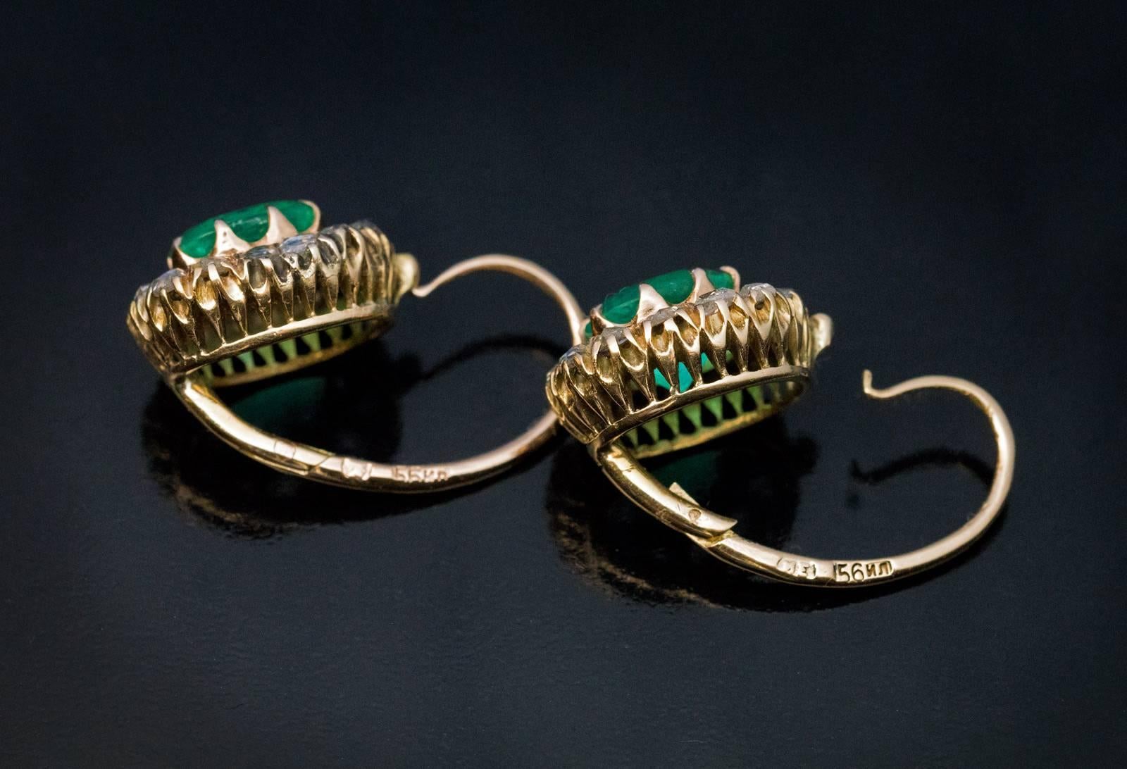 Made in Moscow between 1899 and 1908
Antique 14K gold cluster earrings are set with sparkling emeralds surrounded by old rose cut diamonds.

Estimated weight of the emeralds:  1.29 ct and 1.02 ct.
The earrings are marked with 56 zolotnik Imperial