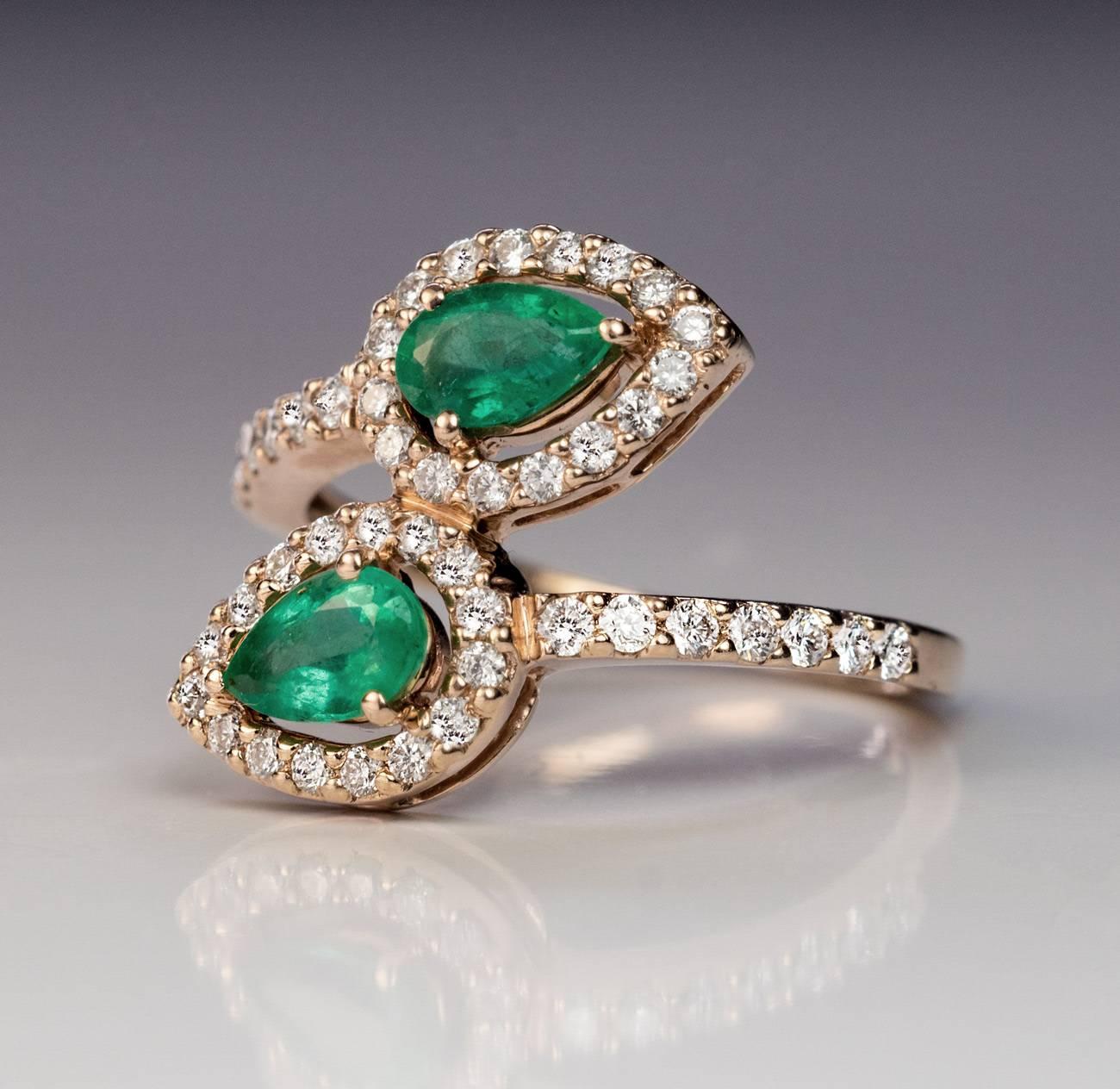 A modern 14K gold bypass ring is set with two pear cut natural emeralds and 46 sparkling bright white brilliant cut diamonds.
Estimated emerald weight 0.39 ct and 0.41 ct

Approximate total diamond weight 0.53 ct
The ring is marked with Russian 585
