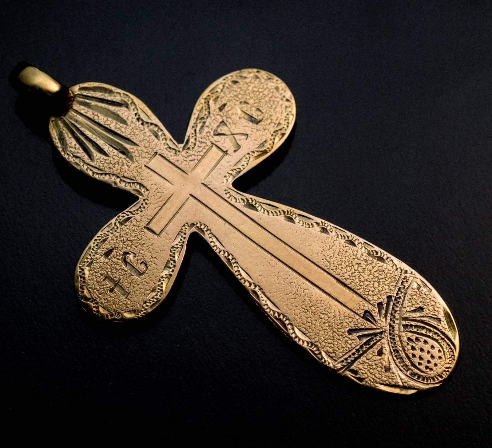 Made in Odessa in the 1870s
An antique 14K gold cross pendant is hand engraved with a shaded pattern.  The abbreviation IC – XC on the horizontal arms of the cross stands for Jesus Christ.
The cross is marked on back with maker’s initials, 56