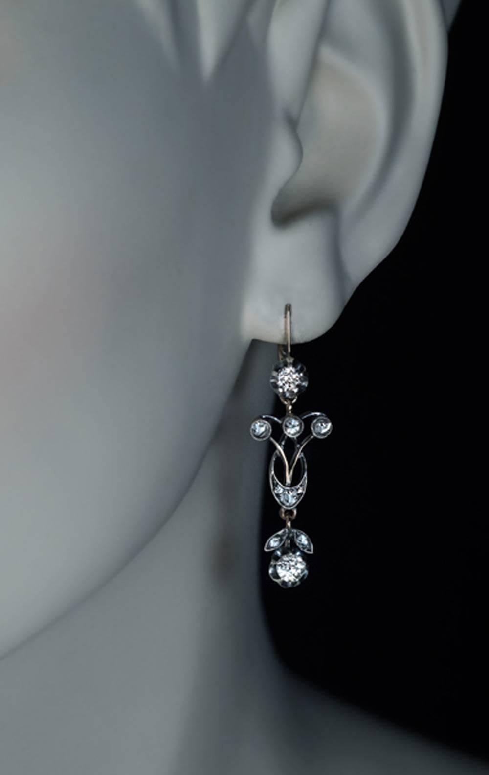 Russian, made in Moscow between 1908 and 1917
A pair of delicate antique silver over 14K gold pendant earrings is set with old European and old rose cut diamonds.
Estimated total diamond weight is 1 carat.
The earrings are marked with 56 zolotnik
