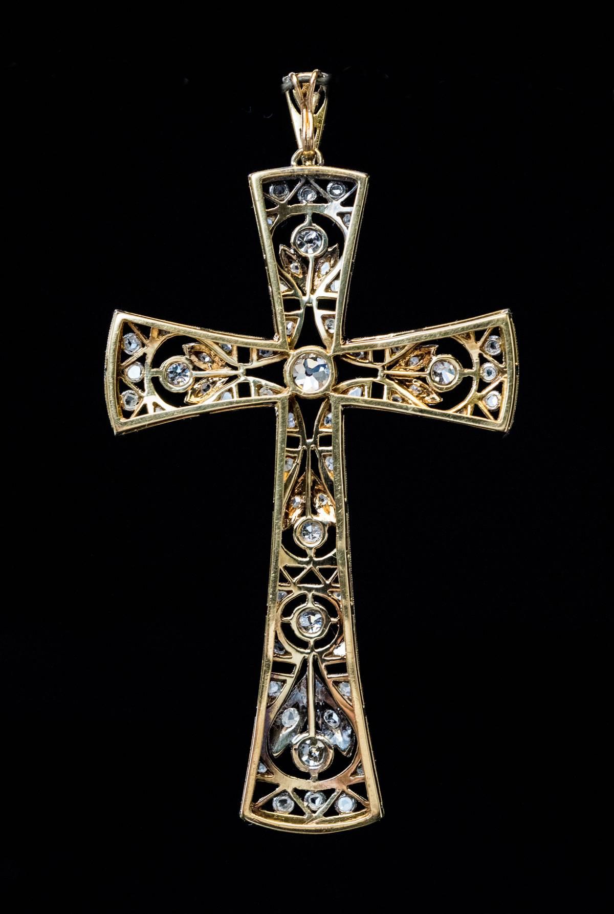 Circa 1905
This large antique cross pendant from Edwardian era is embellished with garland-motif openwork designs.  The cross is set with old mine brilliant and rose cut diamonds.
Estimated total diamond weight is 1.30 ct.
Total length with bail is