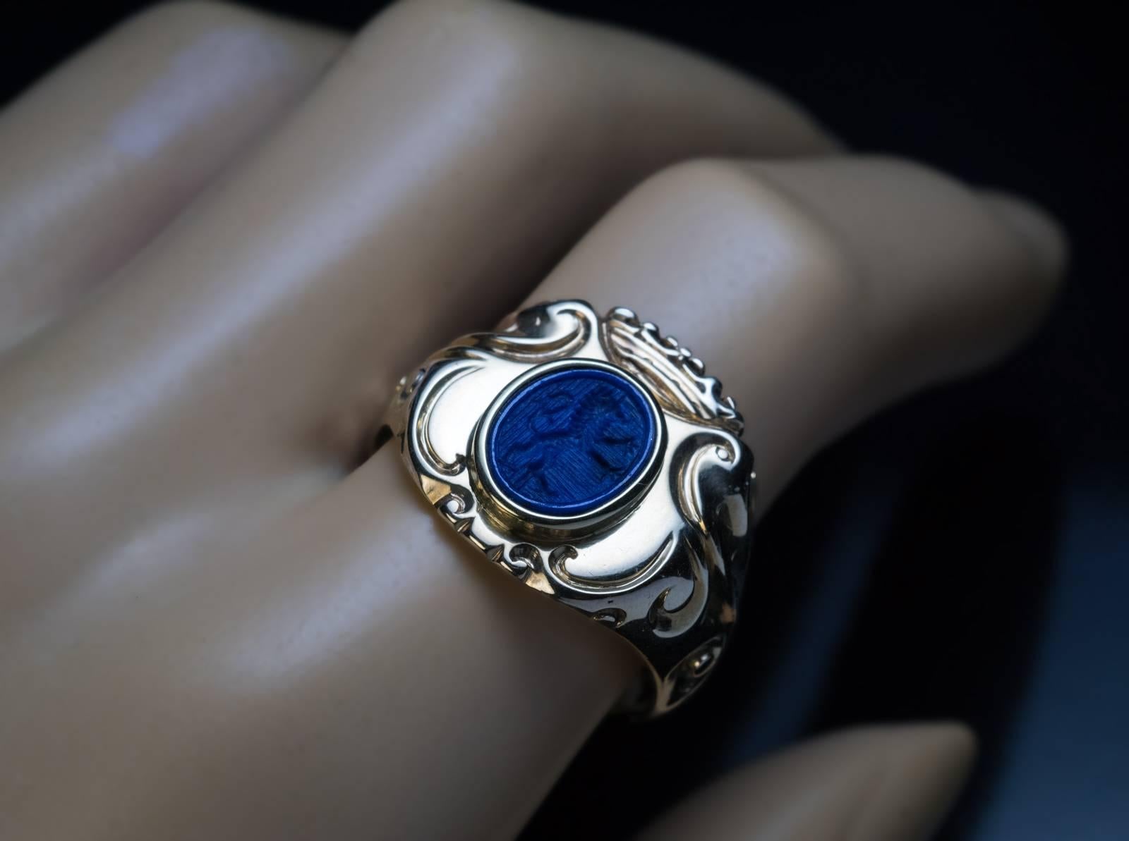 Austrian, c.1870
This one-of-a-kind antique 14K gold armorial signet ring is designed as a crowned ornate shield centered with a lapis lazuli intaglio crest carved with a walking lion. The shoulders of the ring are embellished with scrolling designs