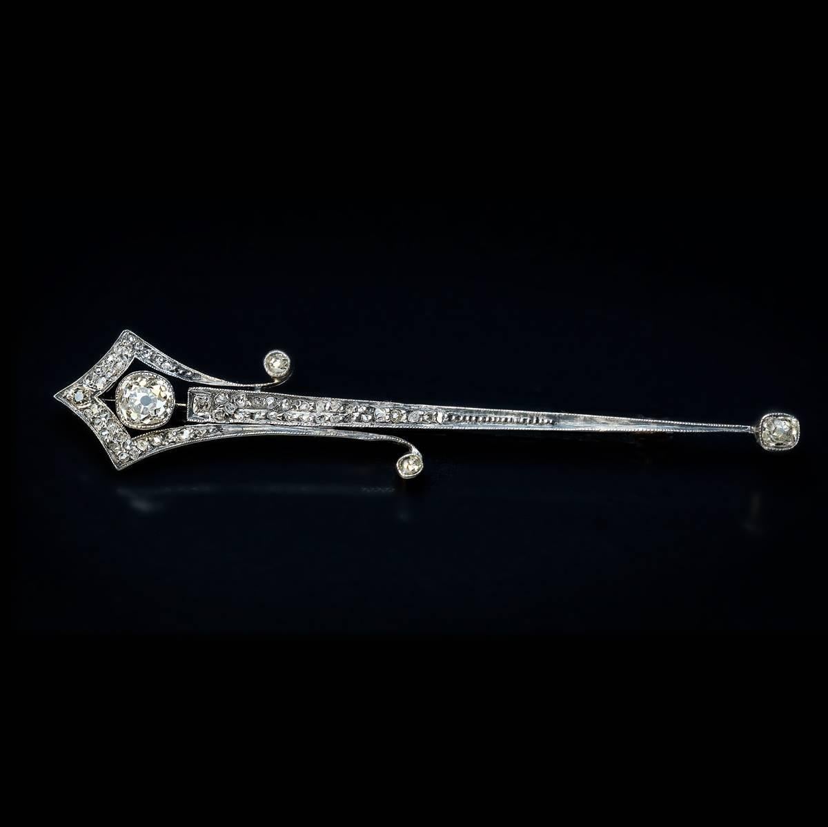 This stylish arrow motif antique brooch / pin was made in Russia around 1910. The brooch is handcrafted in silver topped 14K gold and set with old cushion and rose cut diamonds.

It is likely that the design of this brooch was inspired by Helley’s