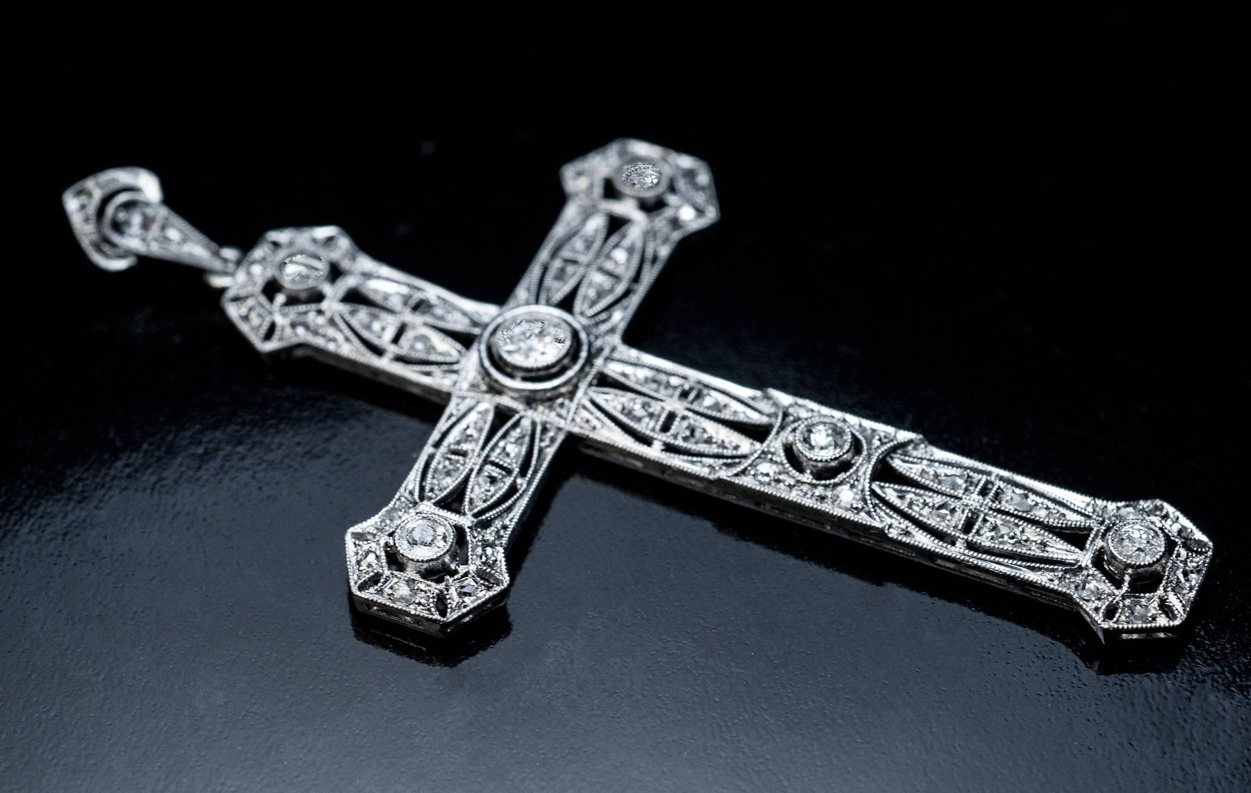 Circa 1910

This large Edwardian era antique openwork cross pendant is handmade in platinum and embellished with old European and rose cut diamonds.

Estimated total diamond weight is 0.80 ct.

Total length with bail 65 mm (2 1/2 in.)
