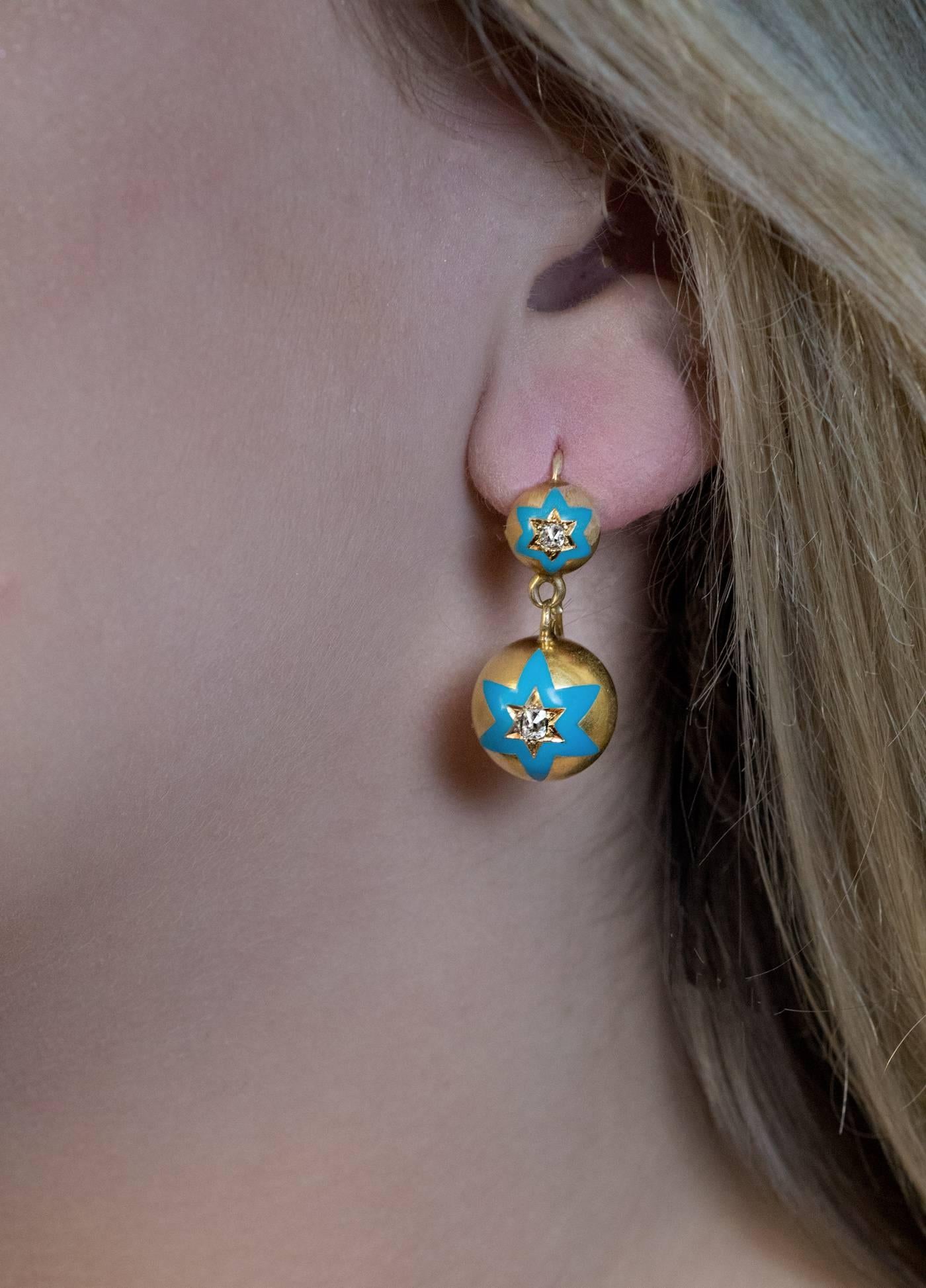 Made in St. Petersburg between 1908 and 1917

Antique 14K gold spherical earrings are embellished with turquoise blue enamel six pointed stars centered with old cushion cut diamonds.

Estimated total diamond weight is 0.60 ct.

The earrings are
