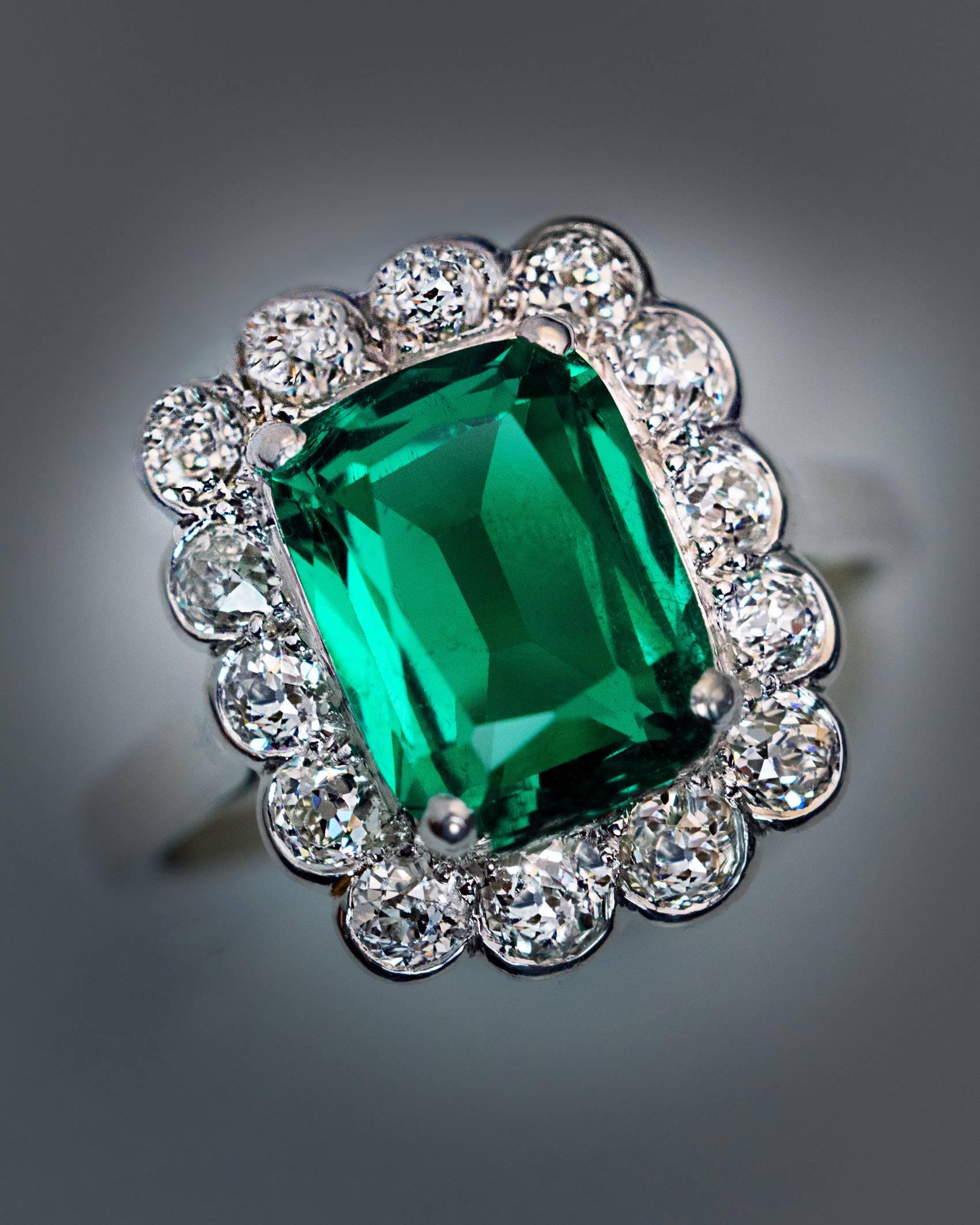 Circa 1925

This vintage French platinum (head) and 18K white gold (shank) engagement ring features a very rare untreated 2.31 ct Colombian emerald. The cushion cut emerald is extremely clean and full of life. The center stone is framed by chunky