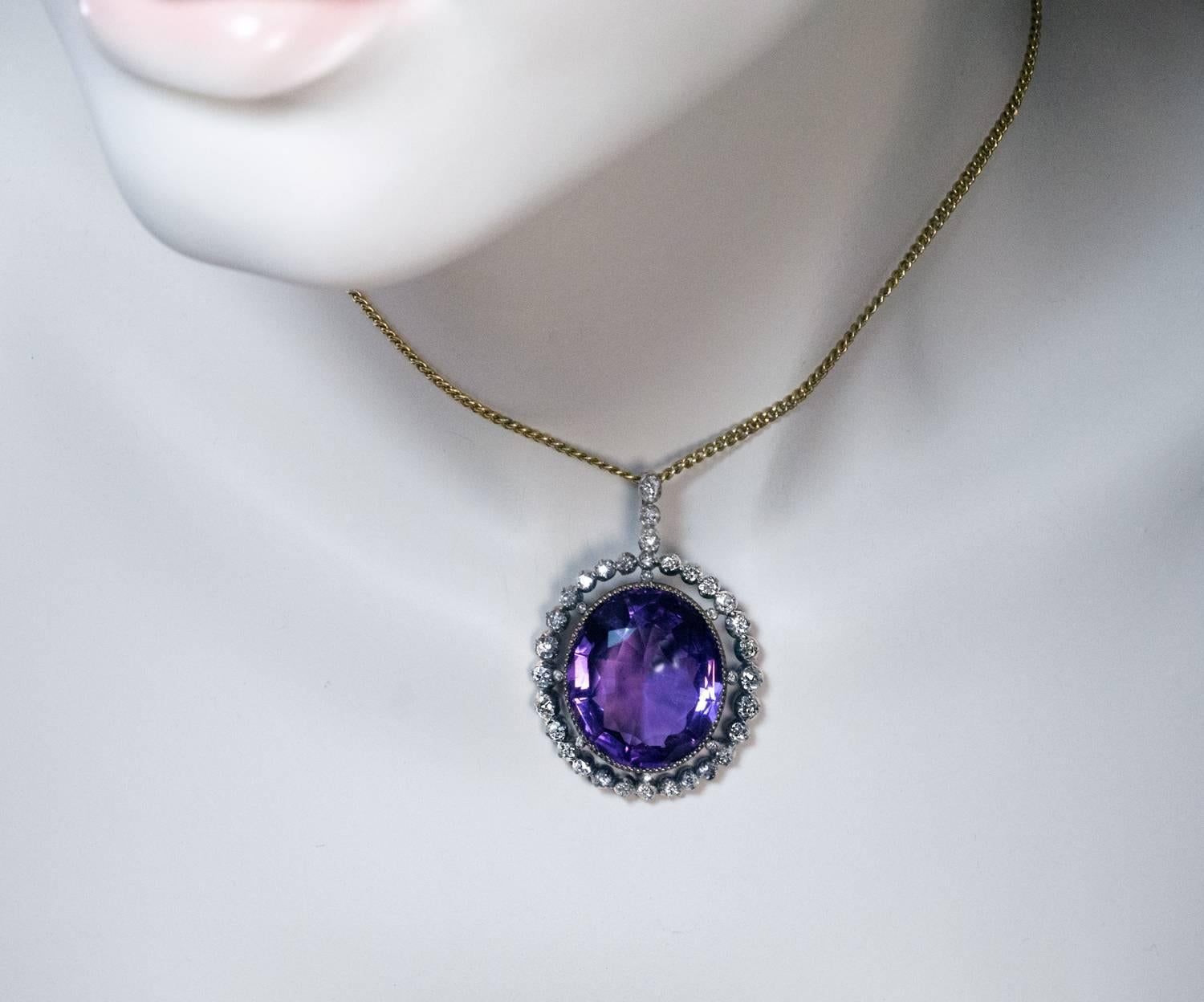 Circa 1870

The silver topped gold pendant is centered with a large oval amethyst (24 x 20 x 11.3 mm, approximately 28.75 ct) set in a diamond frame with diamond encrusted bail.

31 antique cushion cut and 8 old rose cut diamonds

Estimated