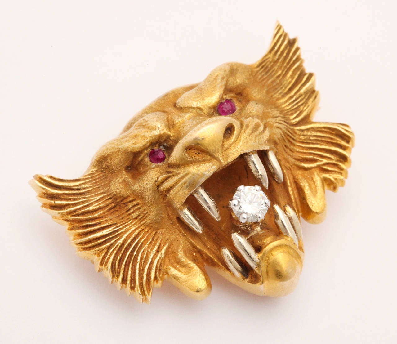 Ruby eyes and a diamond tongue give this Art Nouveau solid gold lion brooch the suggestion of a complex character that can be full of surprises.   With a passionate roar, he or she,  both are capable of loyalty and fierceness, will frighten evil