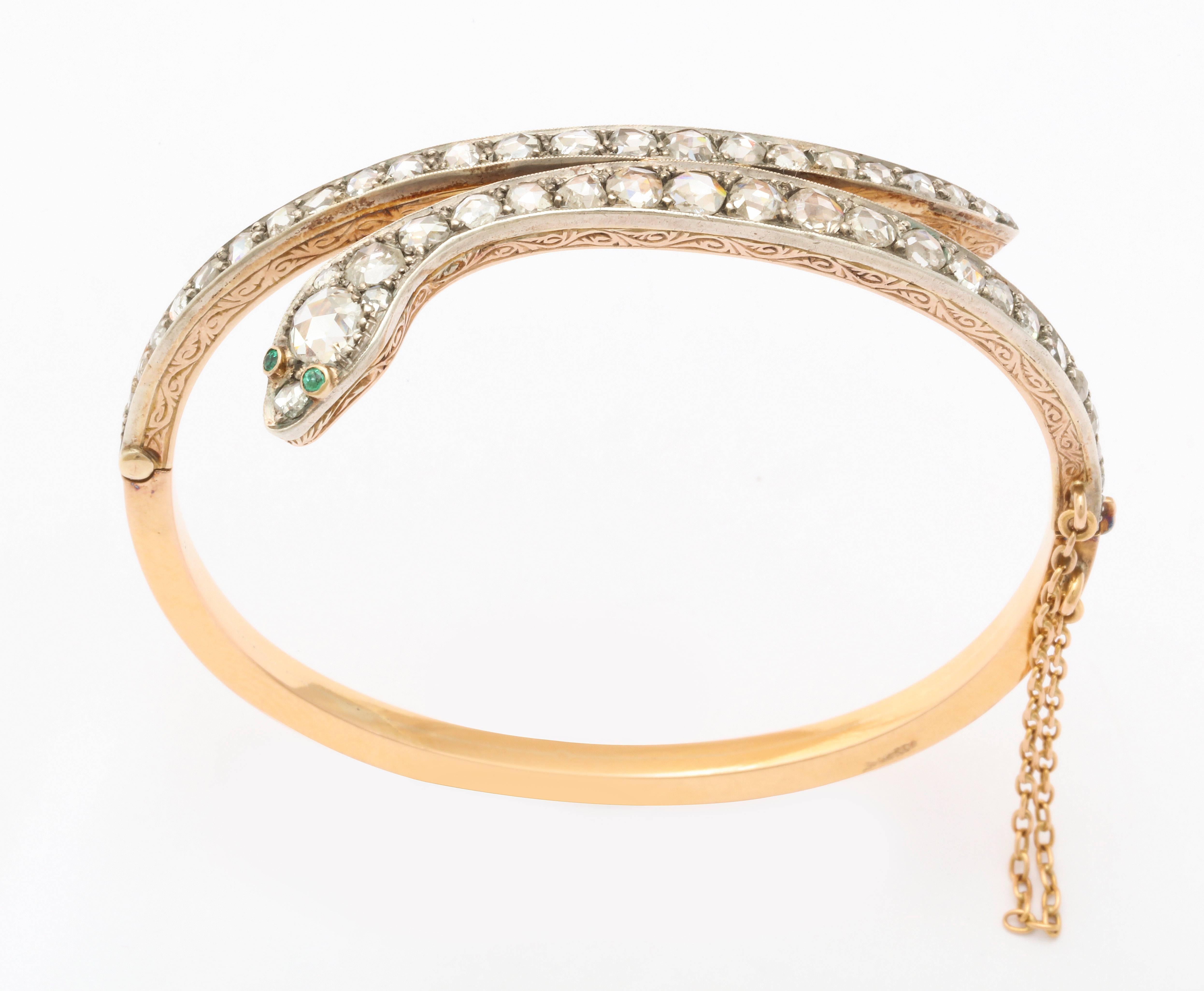 It is easy being Green when green eyes gaze at you from a diamond serpent bracelet of 15kt gold made in Victorian England c. 1860. The serpent cunningly wraps the wrist with the head and tail sections a glitter with antique diamonds. All stones are