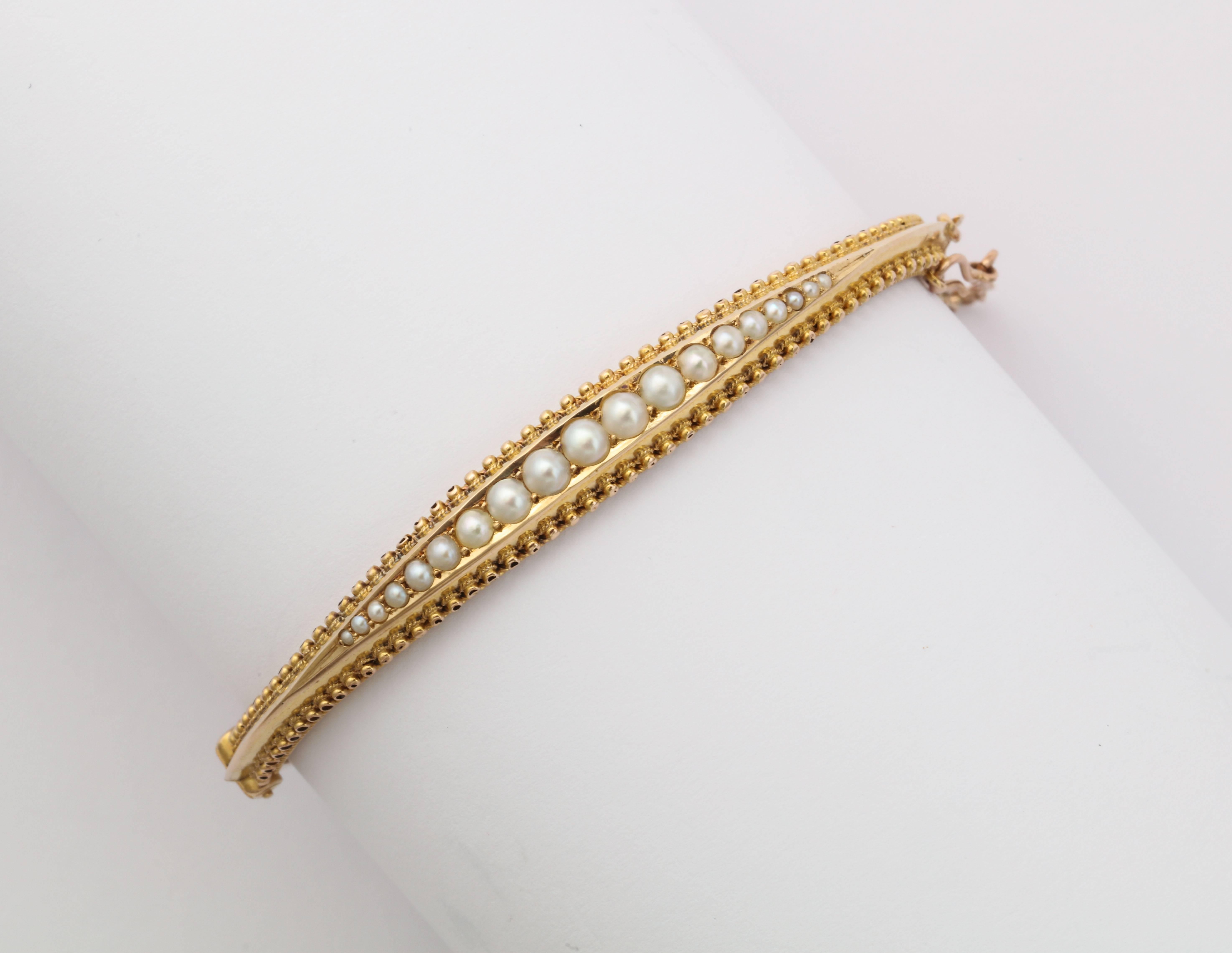 This glowing, beautifully made jewel of a bracelet in 15kt gold, is set with nineteen graduated natural freshwater pearls that are perfectly matched.  The design is timeless and modern though it was created early in the 20th century. At the north