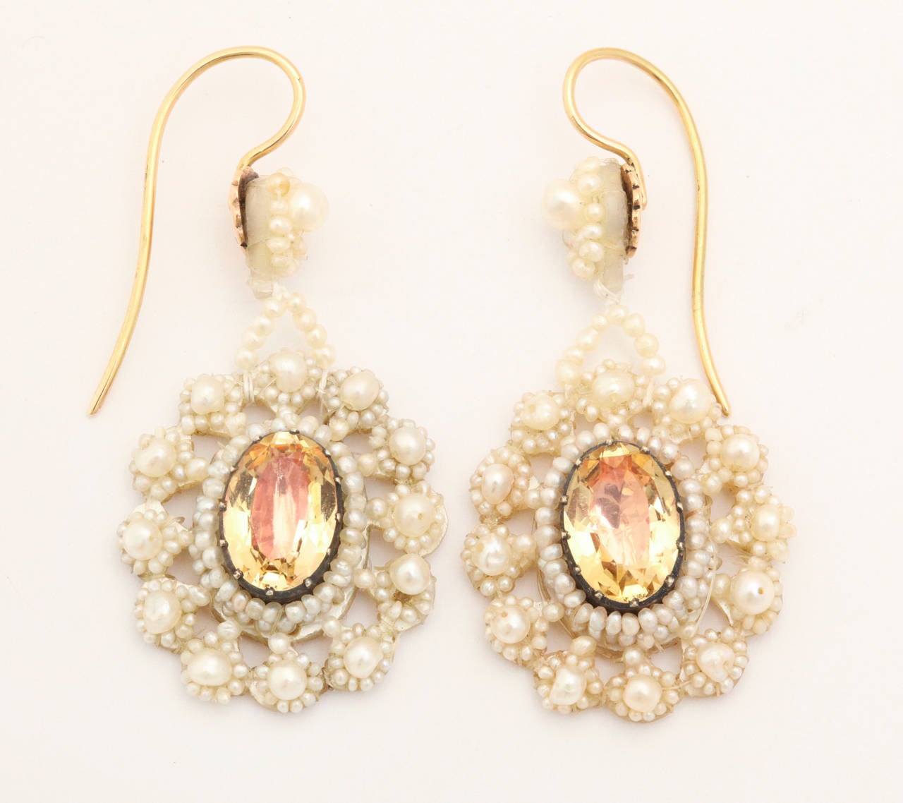 In the late Georgian period through the era, intricate seed pearl jewelry was tradition for young women and brides. Here a pair of chandelier, seed pearl earrings, intricate and delicate, no longer need a wedding to brighten a woman's face, be she