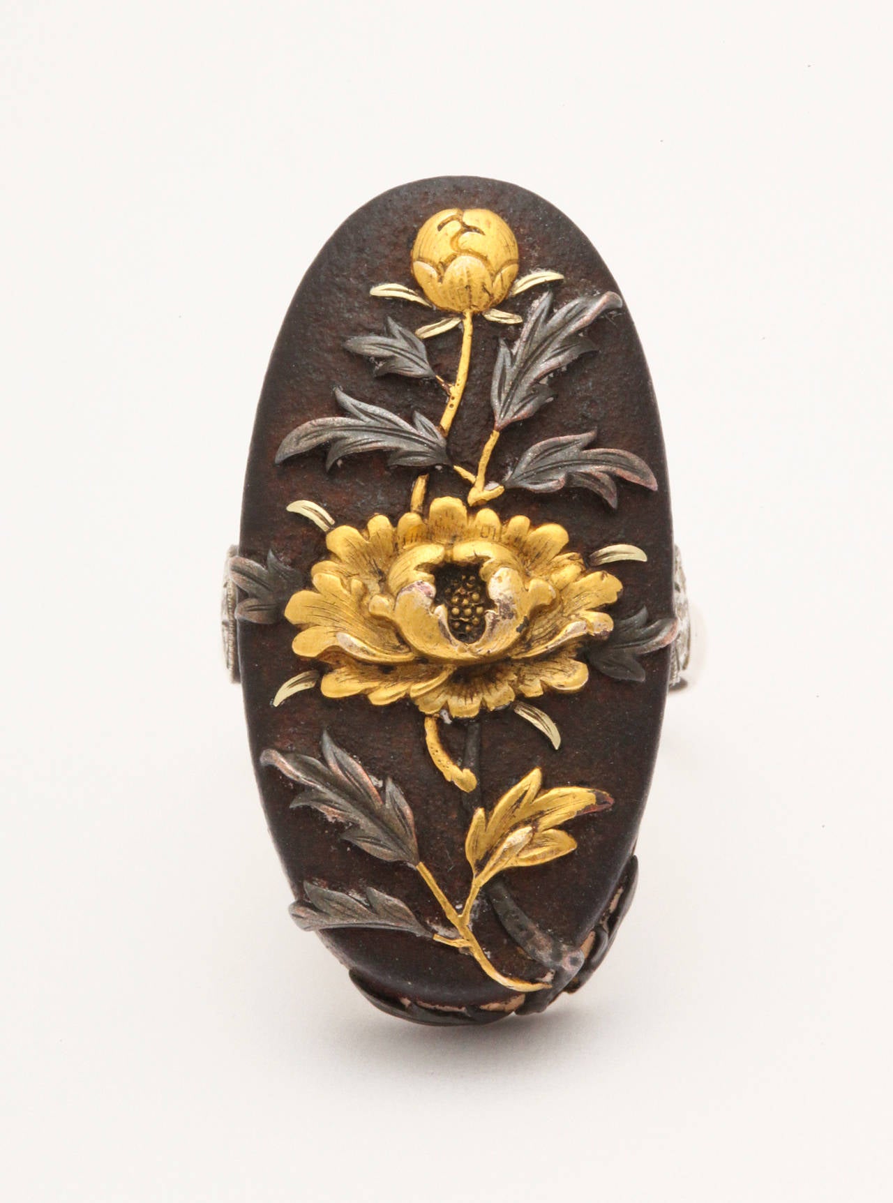 A stunner of a ring in the historic Japanese art form known as Shakudo originated in the Samurai period in Japan by esteemed artists who made ornaments to adorn swords and armor. When the Samurai period ended, these artists moved to making wearable