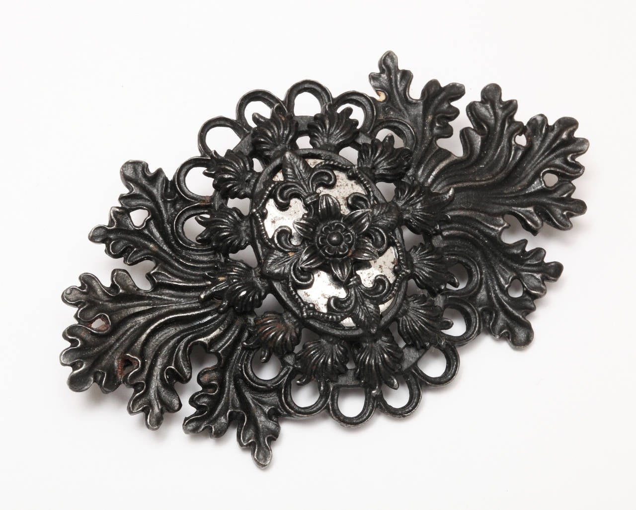 The solid and lacy design of this large Berlin Iron brooch shows the artistic thoughtfulness of the designer to create contrast and interest when placed on the fabric of your clothing. This is the first brooch of Iron we have shown. There are few on