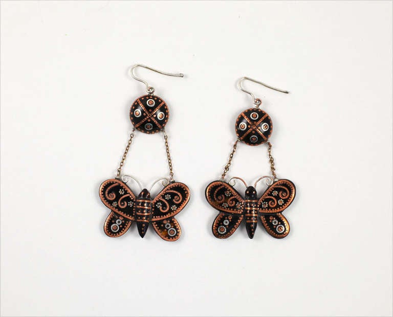 As butterflies in your garden attract attention, so do these unusual earrings.  Rose gold and touches of silver have been delicately incised into tortoise shell to color the butterflies. Light in spirit, the earrings are as free of weight as the