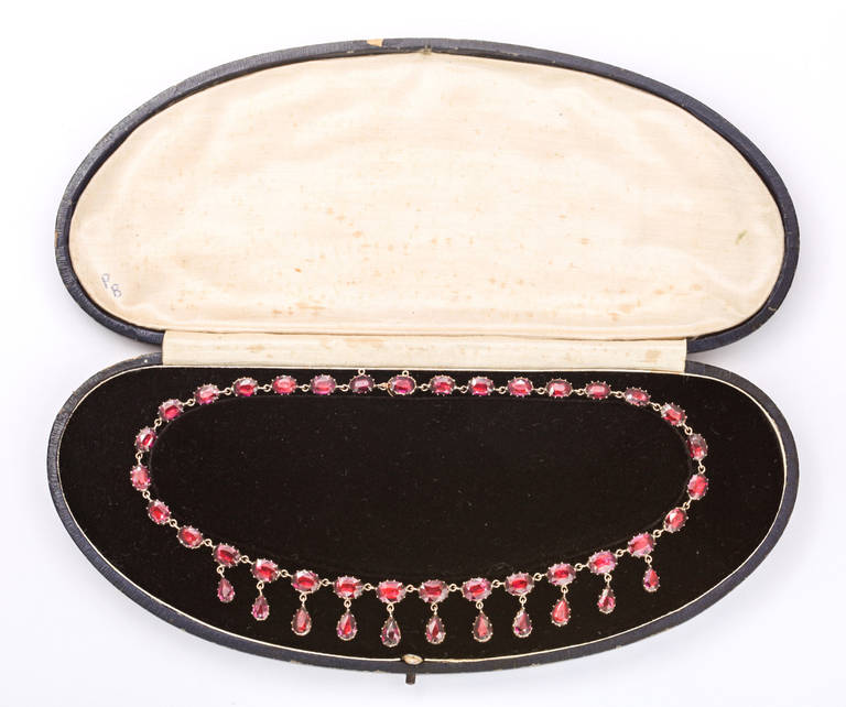 Colors carried symbolic messages in Georgian, Victorian and Art Nouveau Jewelry. Red, a color close to the heart symbolizes passion. Here, a high karat gold necklace, circa. 1820, brings passion to the eyes immediately. The garnets are a saturated
