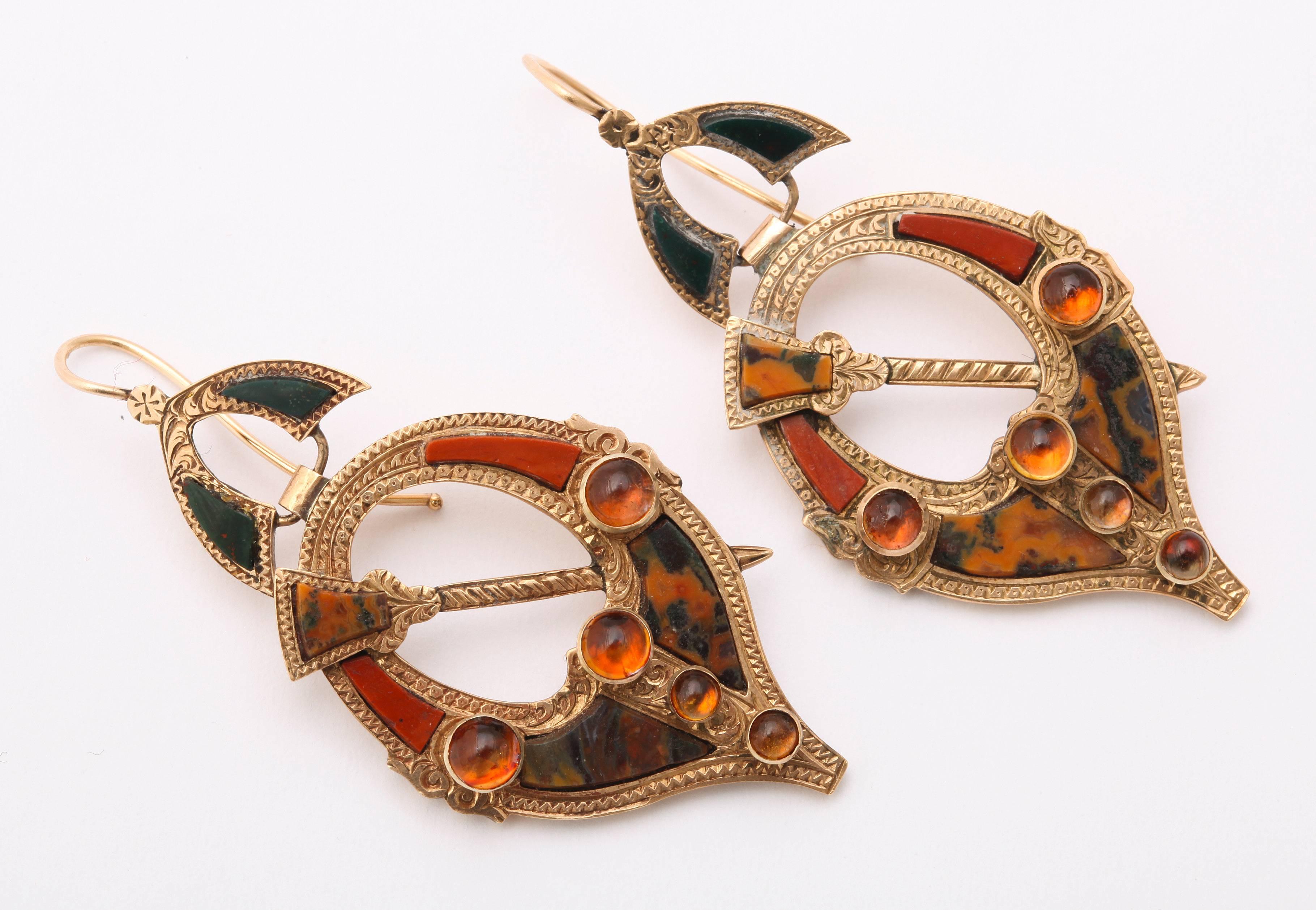 Scottish mastery in jewelry making shines in this antique pair of 15kt gold, agate and cairngorm earrings c. 1860-1880. The form is a penannular,  an incomplete circle that may or may not come to a point. Penannular is a term from the ancient