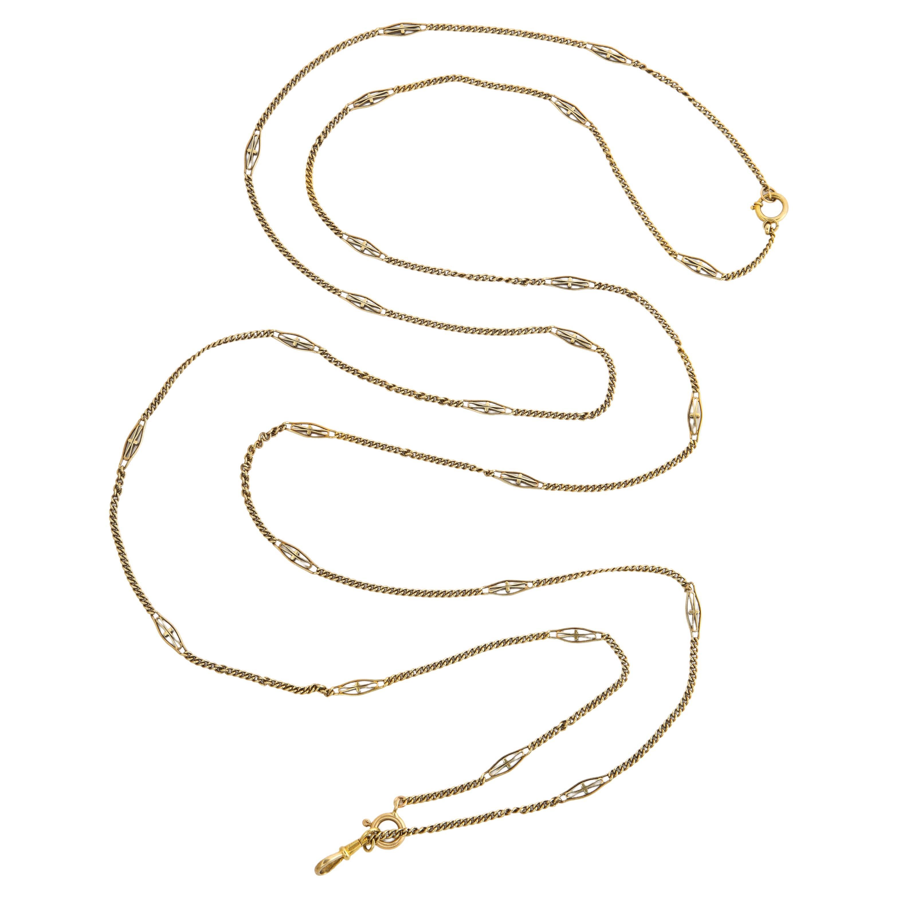 An American made long gold chain that goes on forever or can be divided in two parts. Forever is 65 inches long. intertwined round links are interrupted periodically by oblong links that have a elongated bow shape in their center.. The chain is