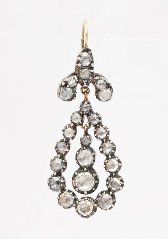 Luxurious 1.80 ct rose diamond chandelier earrings c. 1830 shine and become an every day desire. The gems gleam with a luminous glow as they gracefully dance from the ear lobe. Typical of the Georgian era, the stones are foiled and set in gold in a