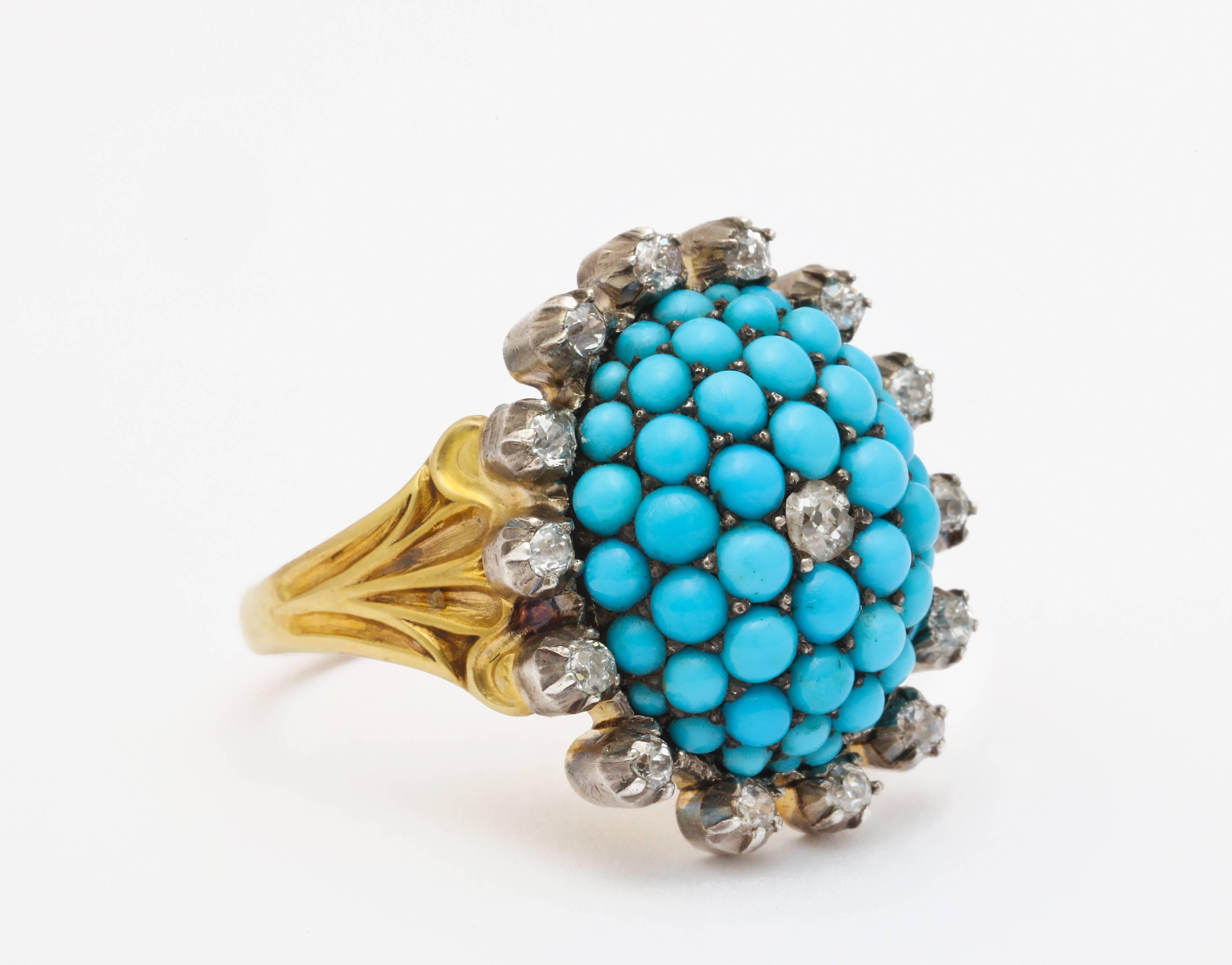 A perfectly matched cluster of sumptuous turquoise from Persia, set in pave,  centered and surrounded by European cut diamonds, is set in a shank of 15 kt gold which is original. The shank is engraved in a simple geometric floral  design almost art
