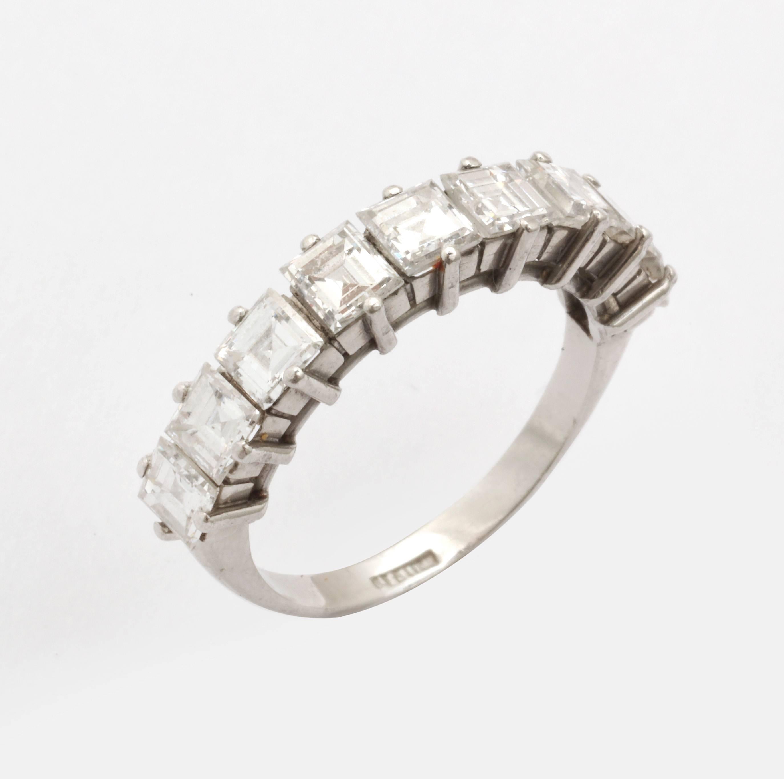 A fine two-thirds hoop eternity band ,in platinum, set with nine square cut white diamonds of .25 carats each, total of 2.25 carats (F-G color; VS clarity.. The makers mark is unclear. The band can be sized. It is currently size 6.  Perfect