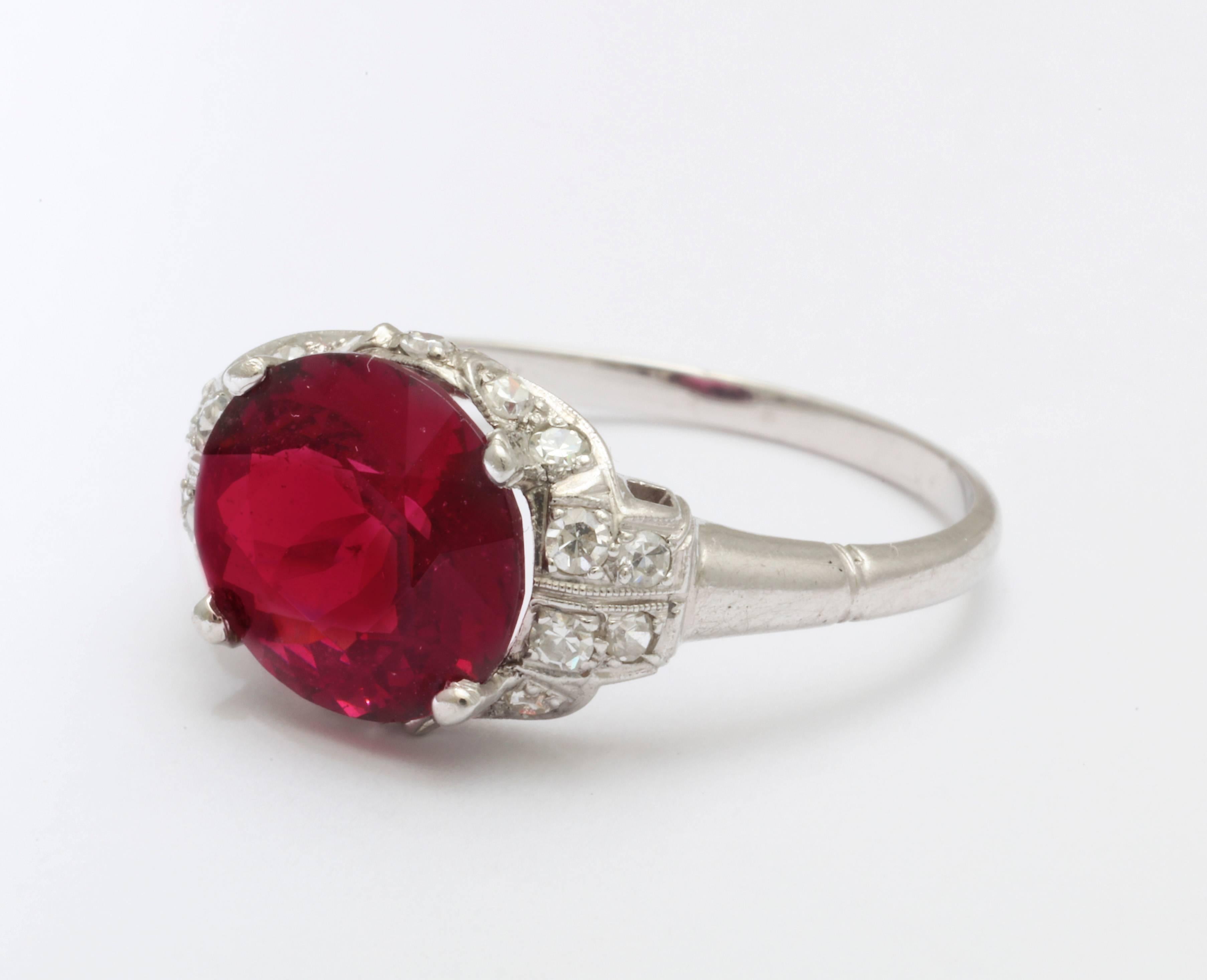 So beautiful you can taste it as an engagement ring or fashion addition, this 3.6 ct rhodolite garnet and diamond ring, from the mid 20th century holds single cut diamonds of .41cts of bright G-H color and VS clarity that surround the red fiery