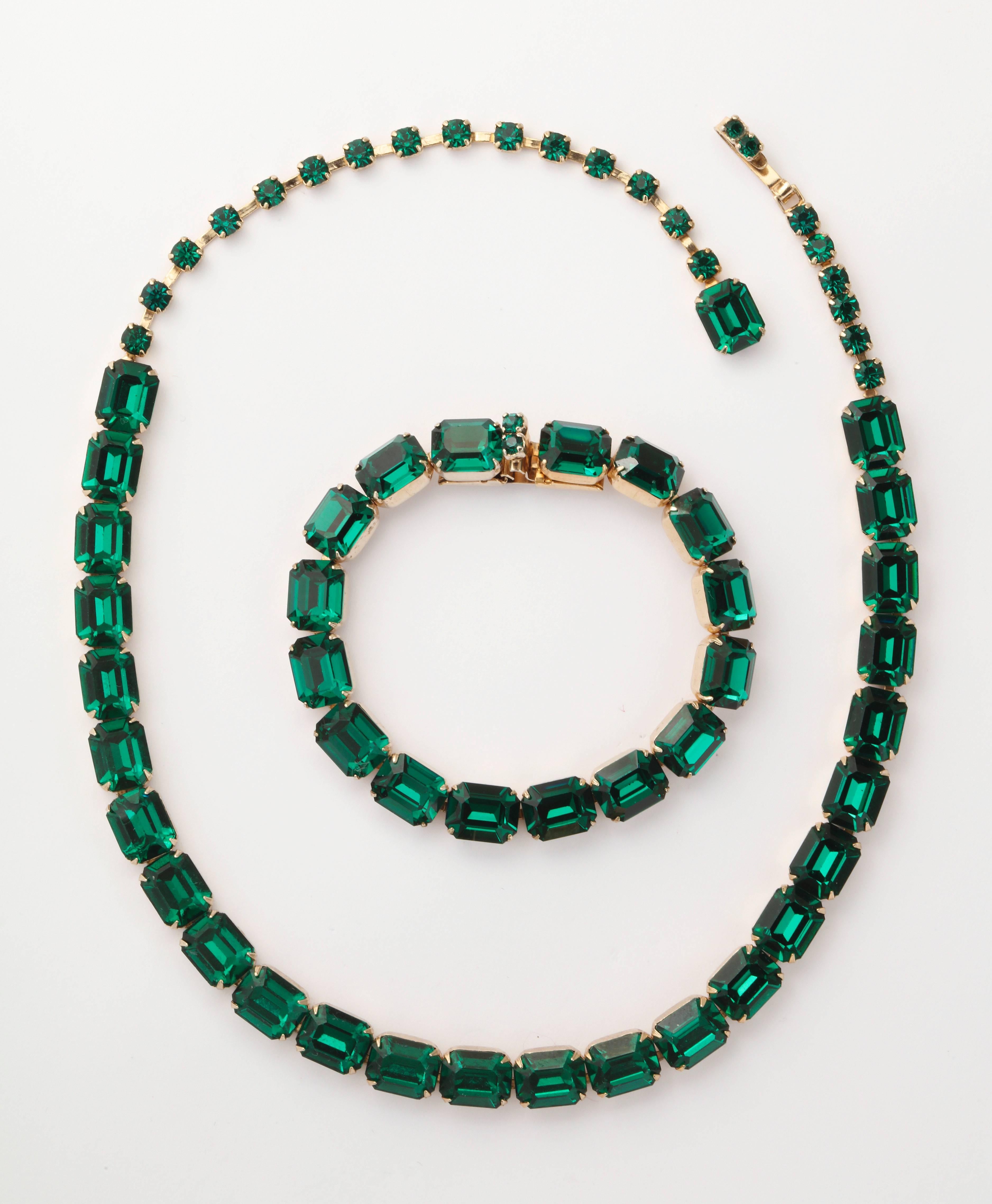 Stunning emerald cut, green Austrian crystal, are artfully set in gold over silver, and radiate with exactly the luscious color of fine quality emeralds. This is a demi parure of rare quality by the Weiss Albert Weiss Company that operated on 5th
