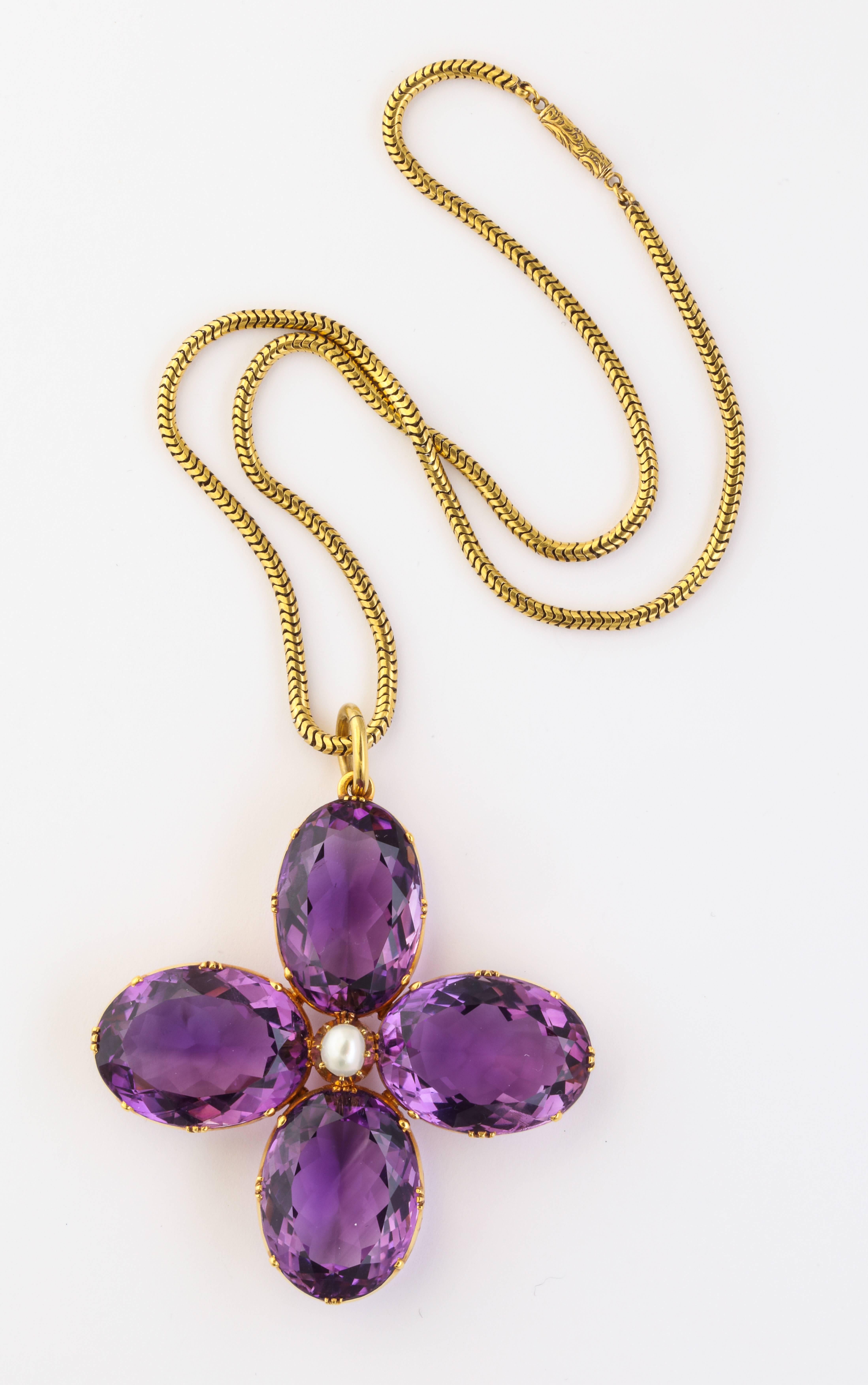 As fresh as today and breathtaking in person at the neck, this chunky 18 Kt amethyst and natural pearl flower comes on its Victorian snake chain. The reality is far more gorgeous than the photograph. When I first saw it, I stopped but did not commit