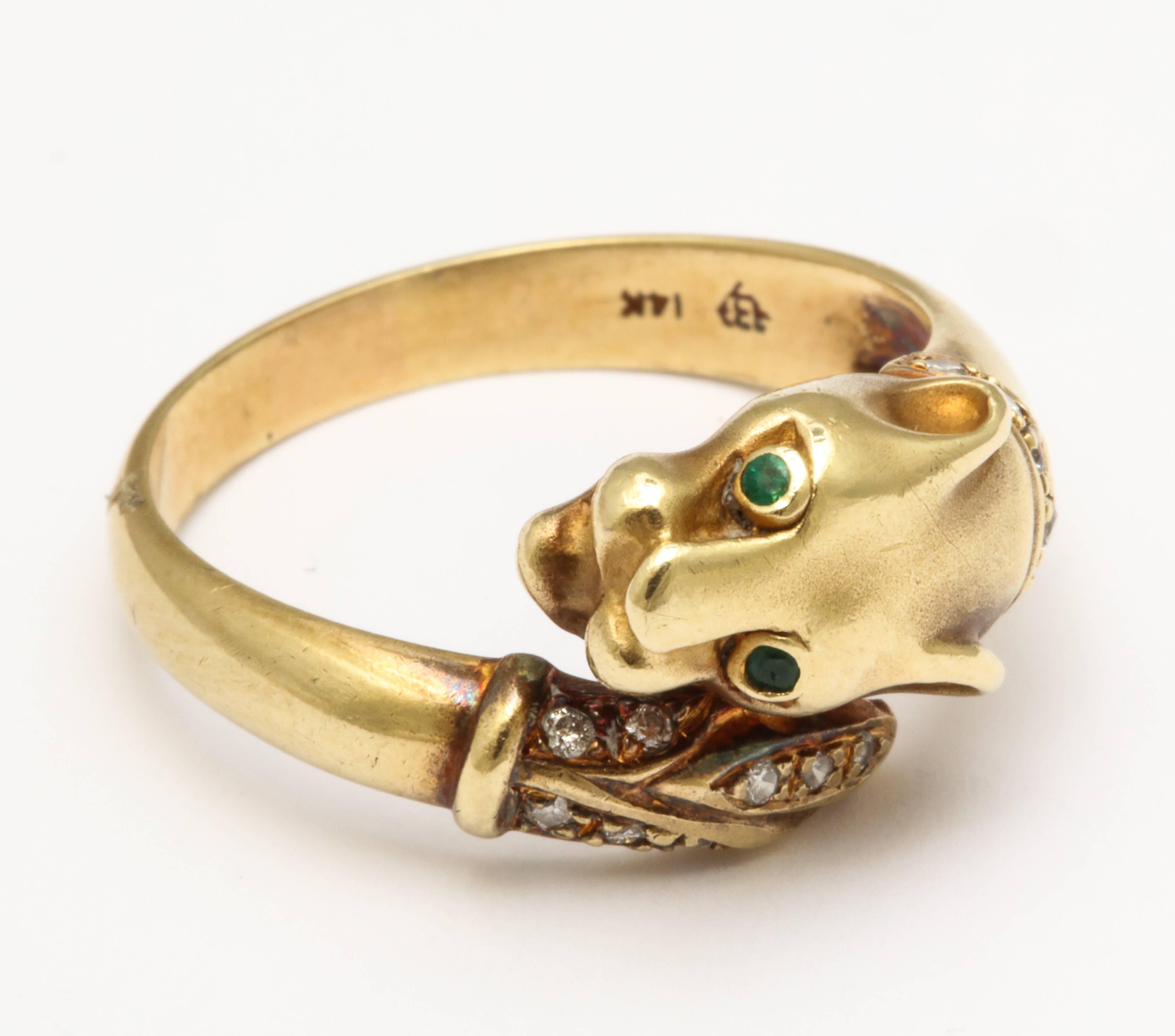 A tamed panther,  almost smiling, with emerald eyes, a tail of tiny full cut diamonds and a diamond collar, wraps around your finger once and is not at all fierce. It is perfect to pair with other rings if desired. The ring has a hefty shank,