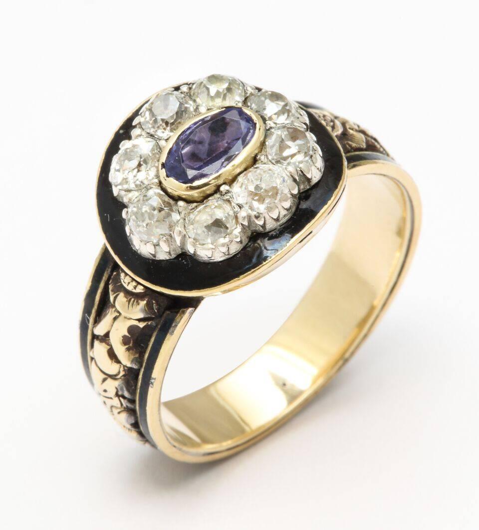An early 18 kt gold, 19th century ring has the kind of beauty that  goes straight from your eyes to your heart with its rich colors of gold, amethyst, white old mine diamonds of approx. .80 cts and black enamel. Around the gold rimmed shank, three