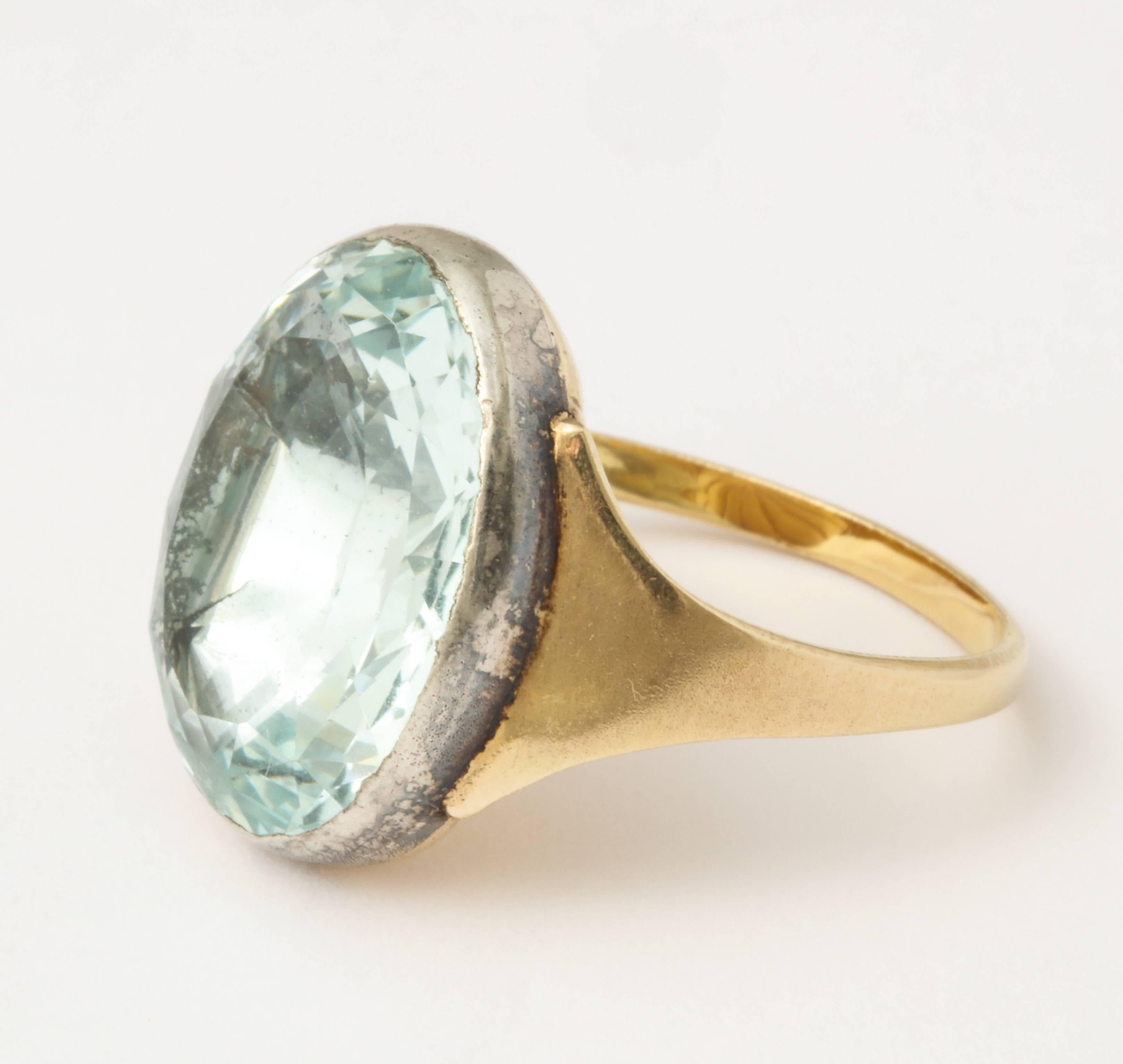 Perfectly clear, absolutely rare,  and not at all shy is this brilliant 12 to 15 ct foiled aquamarine ring set on a 15 kt gold shank. Note that the marks in the stone are due to the depth of  magnification and of the camera. They do not exist in