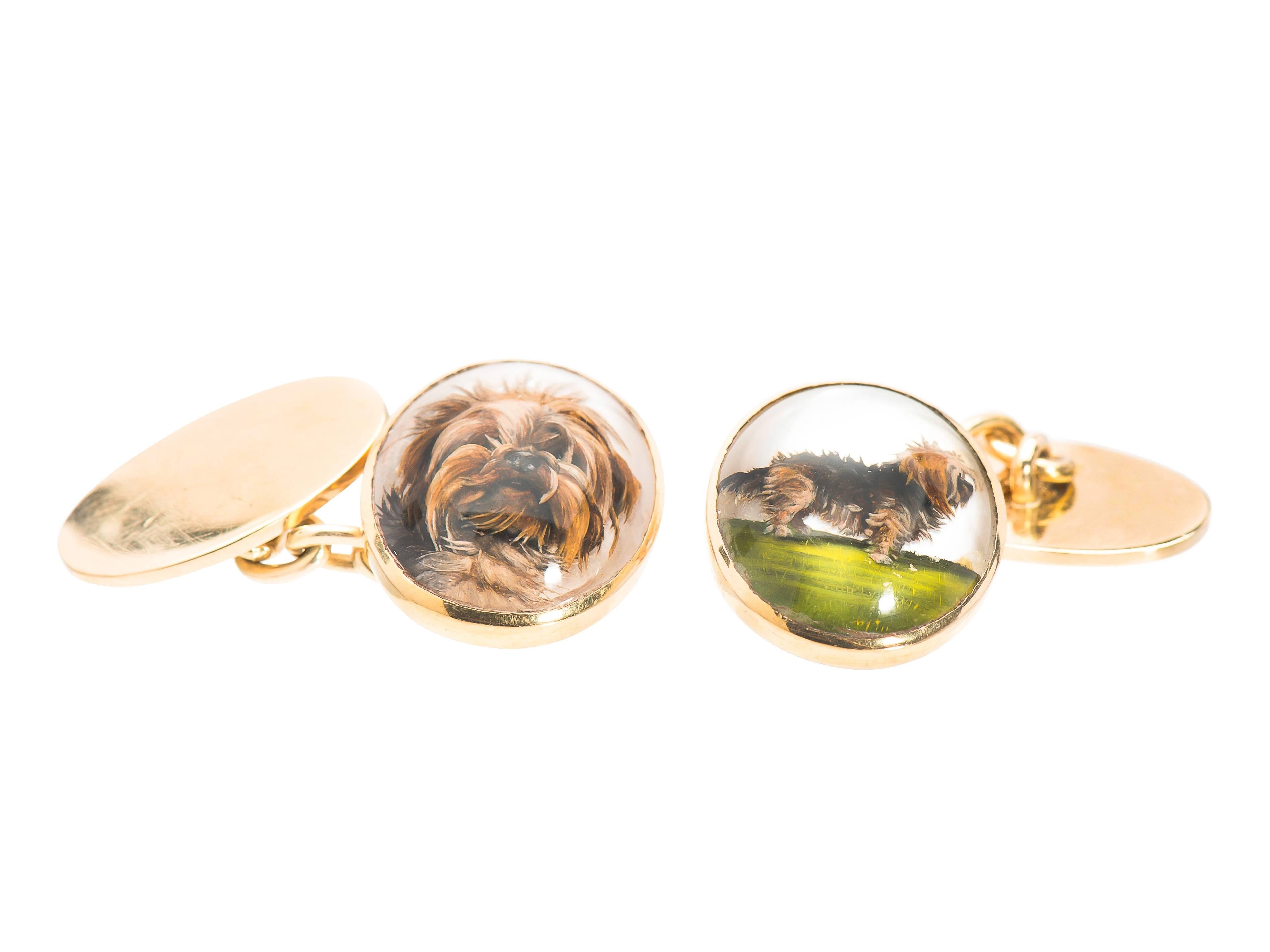 Known as reverse crystal intaglios or Essex crystals, this pair, carved backwards into the back of a crystal, painted in reverse and set in 18kt gold are artist miniature depictions so realistic that you want a terrier kiss. There are two images,