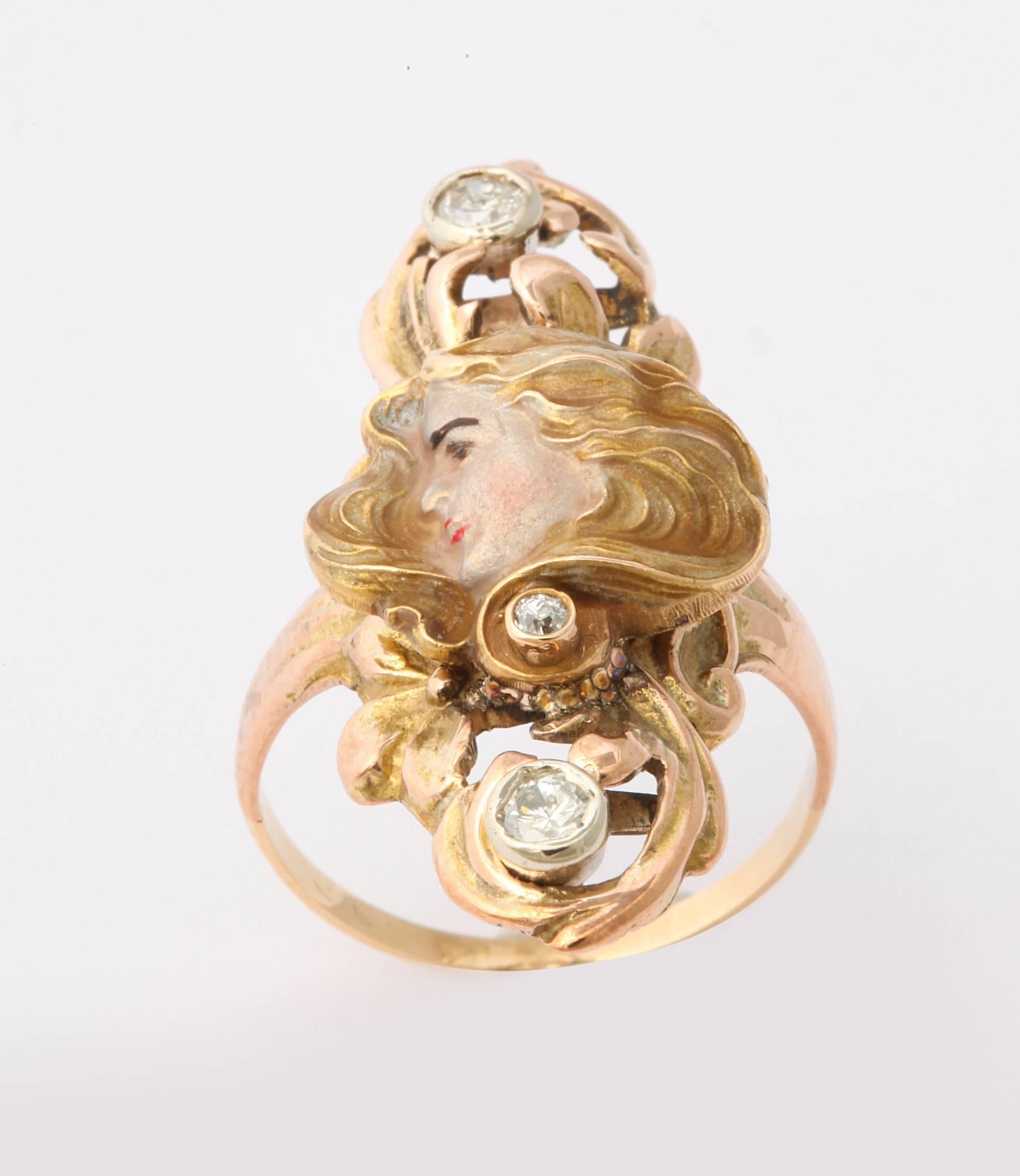 A ring of 14kt in glistening gold and hand painted enamel c. 1890-1915. Windblown to perfection, beautiful to all, a sun lit  woman of nature, the Art Nouveau Lady is idealized in jewelry, posters and paintings. Today we see Vogue models, motion