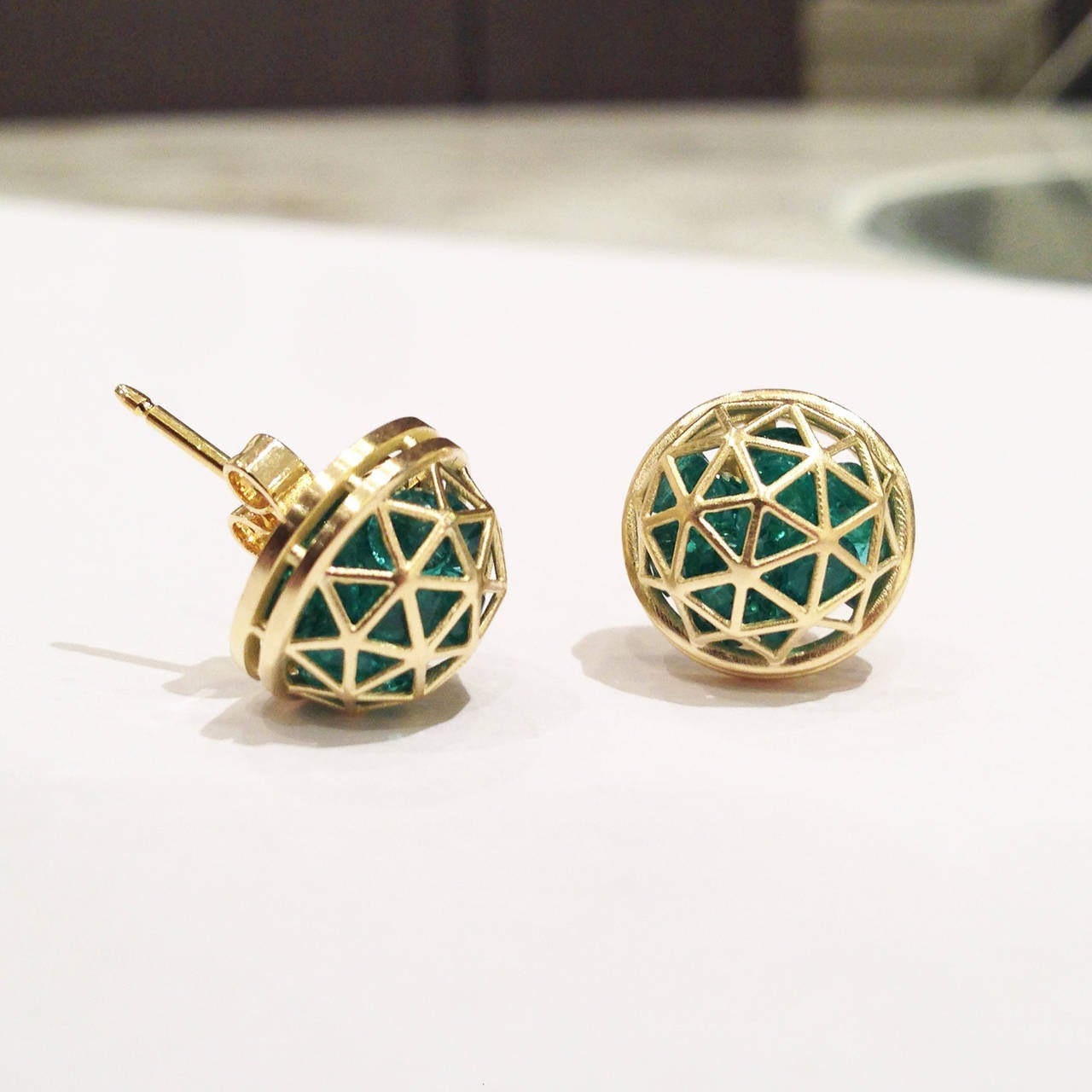 Shaker Dome Earrings crafted in 18k yellow gold with 5.58 total carats of loose emerald gemstones.