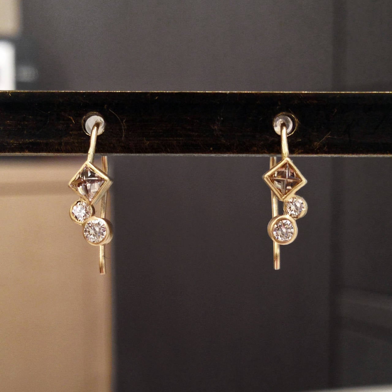 One-of-a-kind Earrings handcrafted in 14k yellow gold with two inverted princess-cut cognac diamonds and four round, brilliant-cut white diamonds. Gorgeous sparkle.