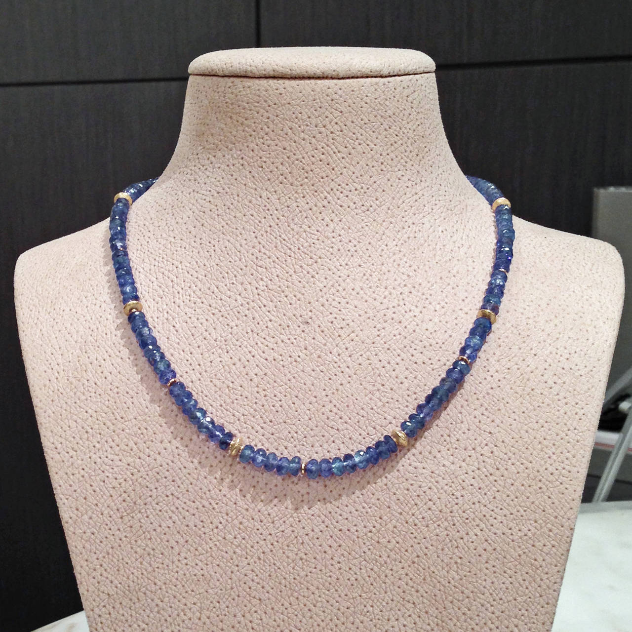 One-of-a-Kind Tanzanite Necklace handcrafted by award winning jewelry artist Barbara Heinrich showcasing faceted tanzanite beads and accented by  assorted matte 18k yellow gold spacers and an 18k yellow gold wavy toggle clasp. 17.25 inches in