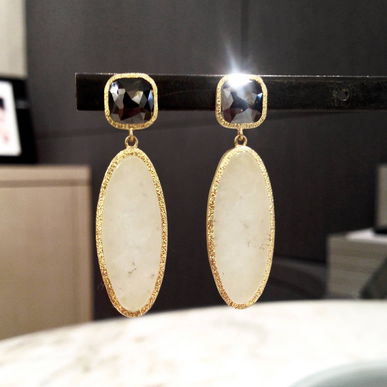 One-of-a-Kind Earrings handcrafted in 22k yellow gold with smooth, reflective white jade drops attached to shimmering faceted black diamond tops.